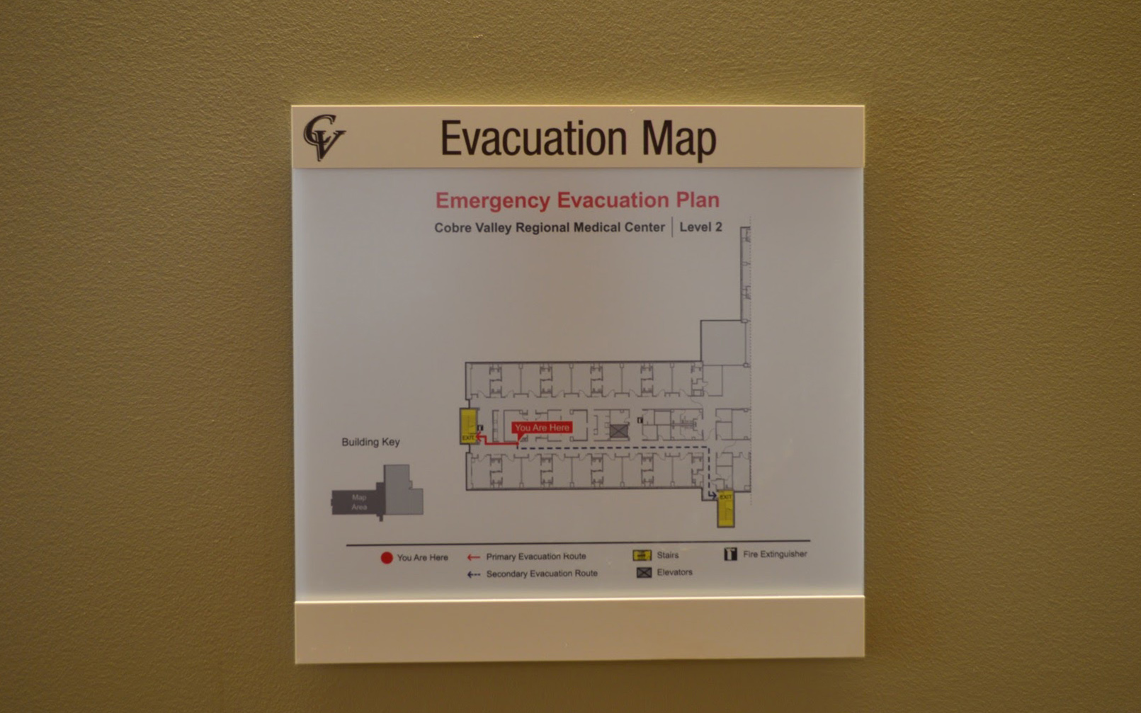 Close-up of a hospital emergency evacuation map in a wall-mounted document holder