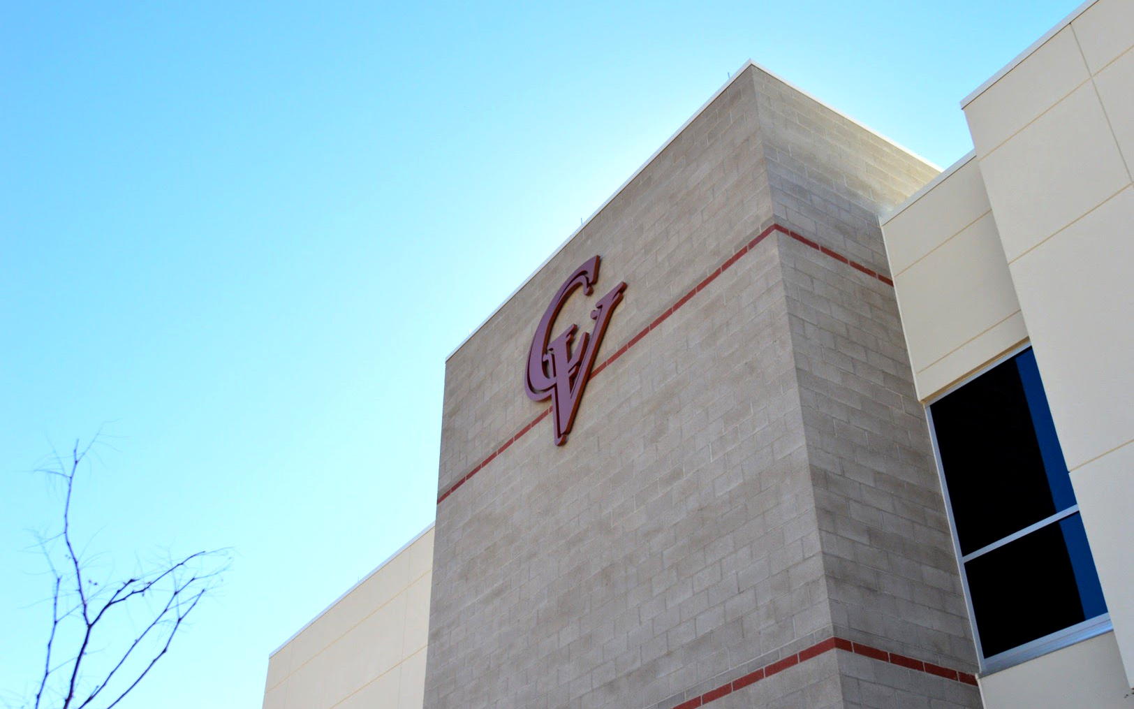 Close-up of the dimensional Cobre Valley Regional Medical Center logo mounted on a masonry building tower