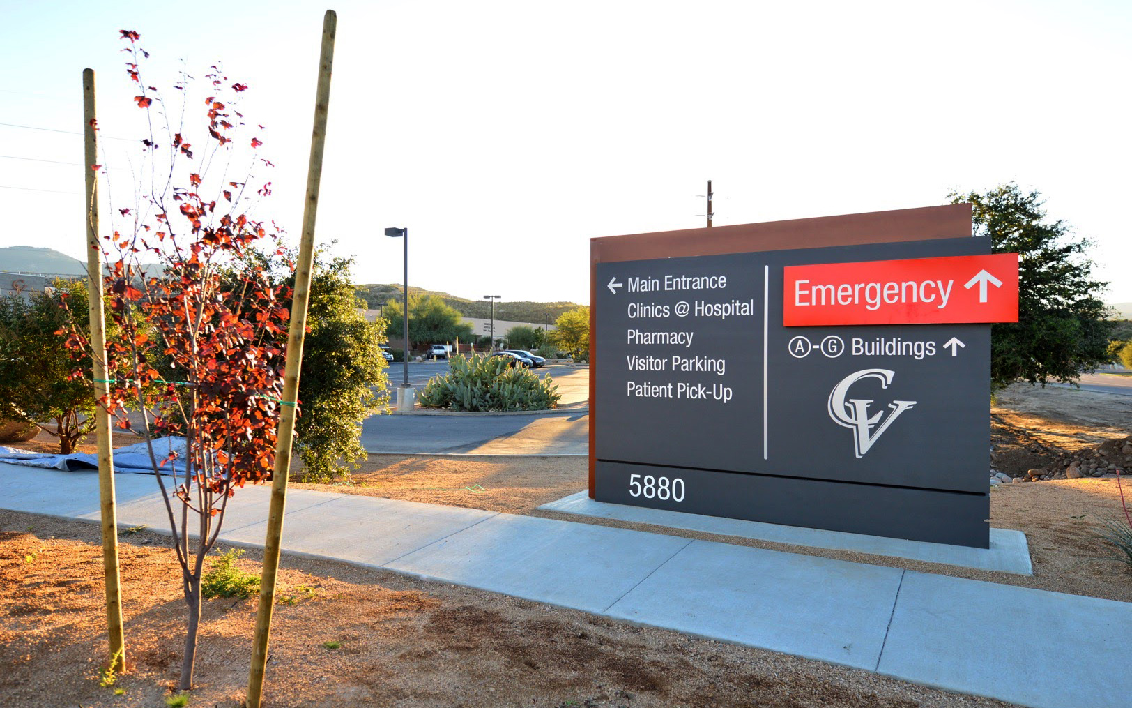 Freestanding hospital monument directing visitors toward emergency services, the main entrance, clinics and patient pick-up