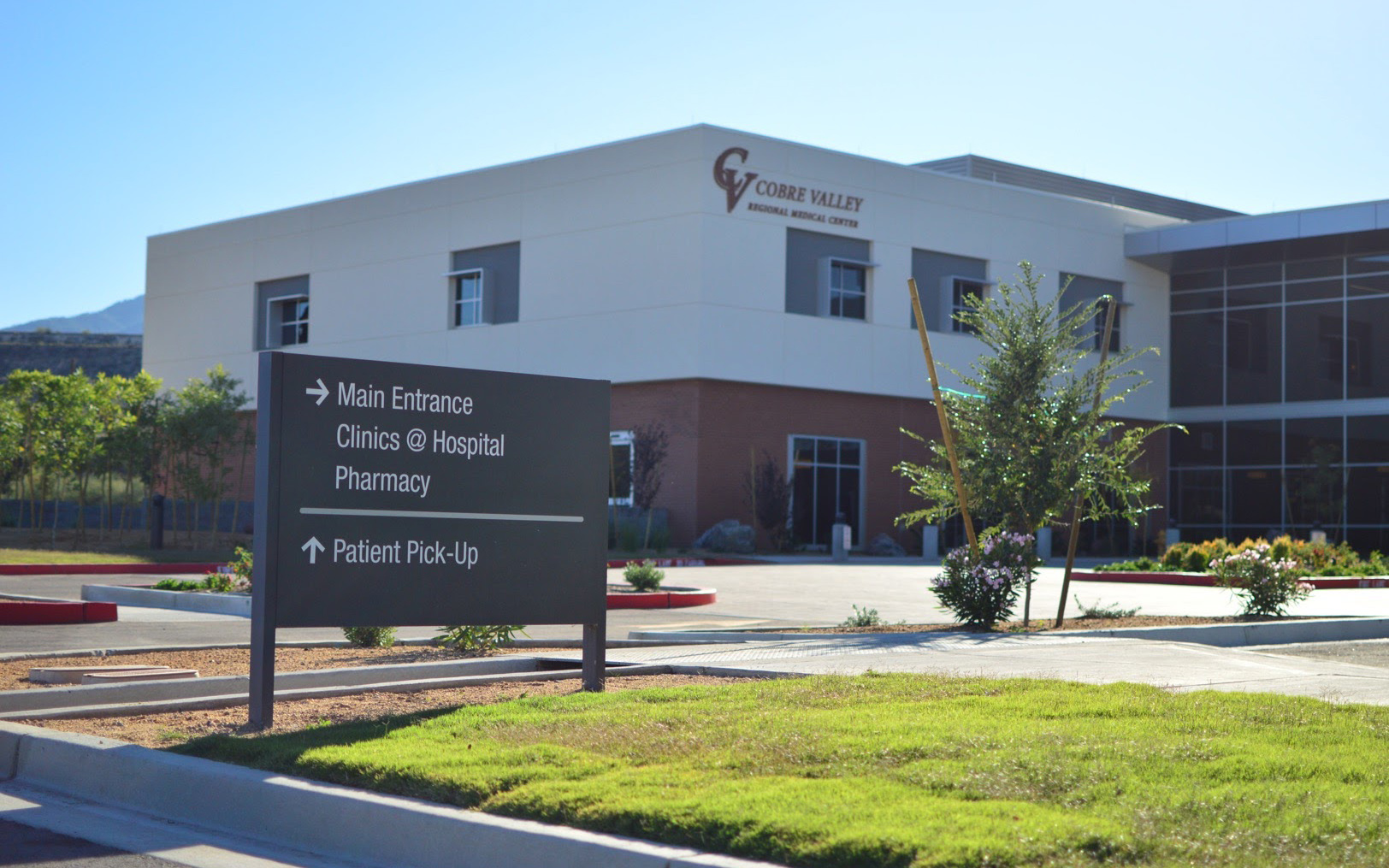 Exterior post-and-panel sign directing vehicles toward the hospital patient pick-up area
