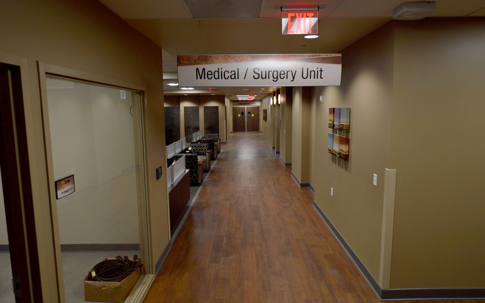 Overhead suspended sign identifying the Medical and Surgery Unit in a hospital corridor