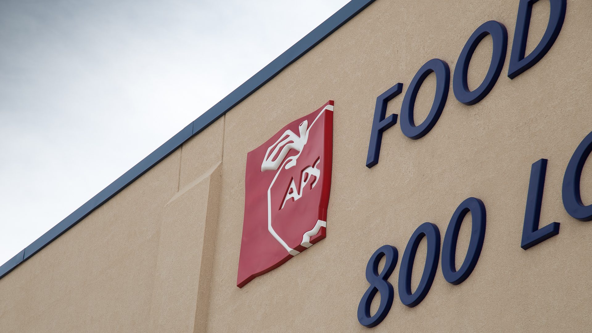 Formed Plastic Dimensional Letters & Logo Detail Image on Tan Building