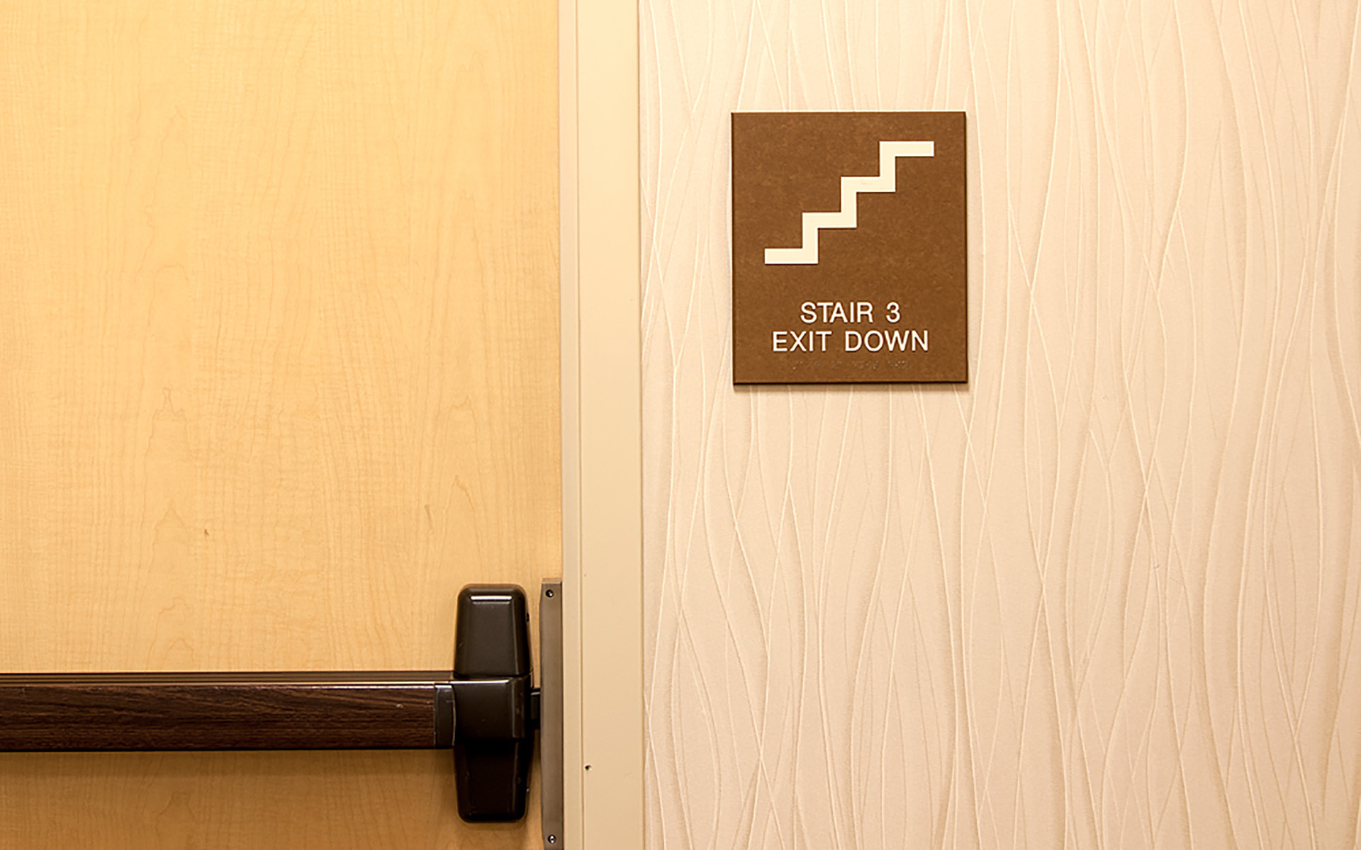 ADA Stair Exit Room Sign located in hallway