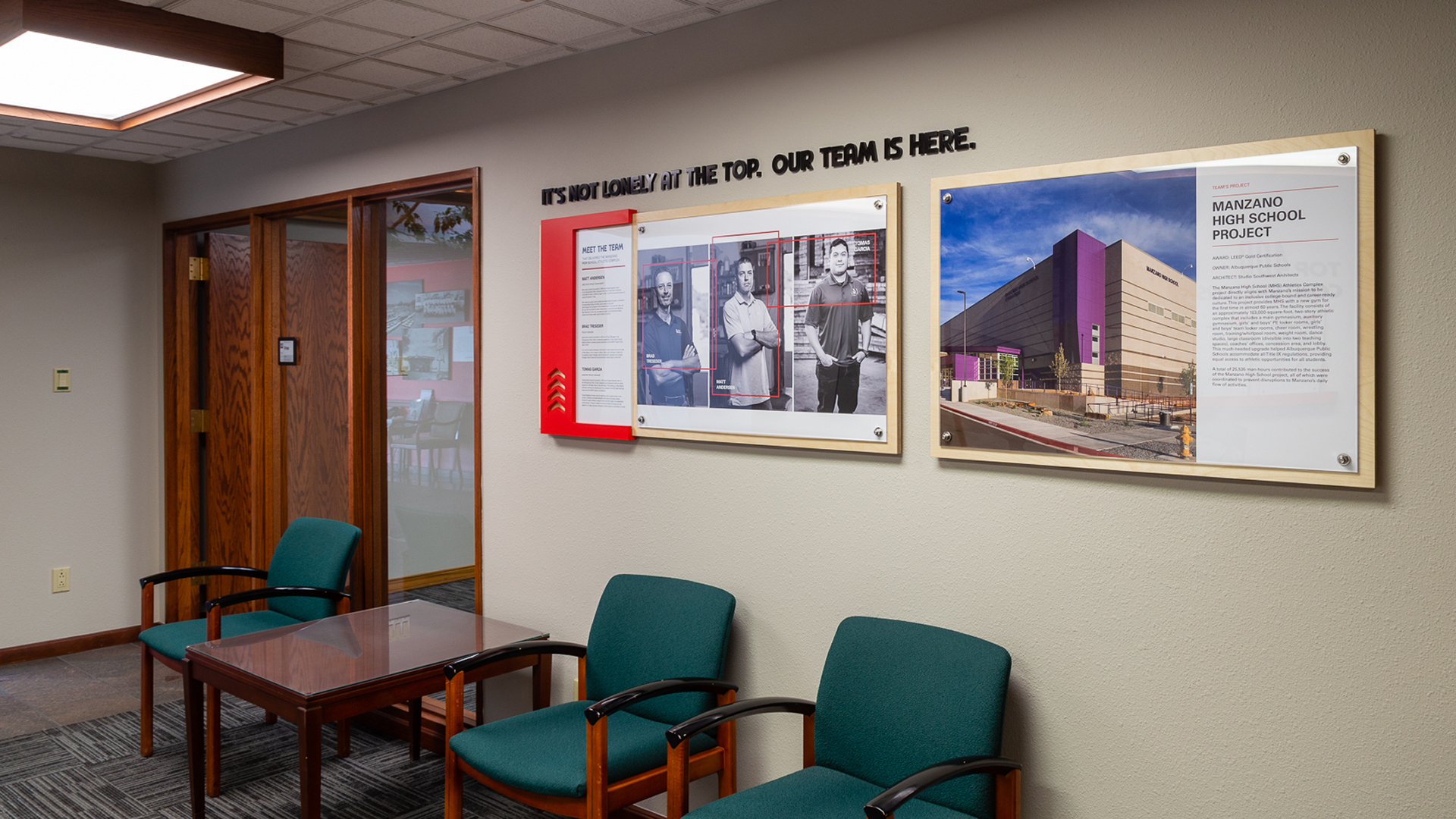 Corporate interior wall with custom branding displays and stand-off mounted panels in office waiting area