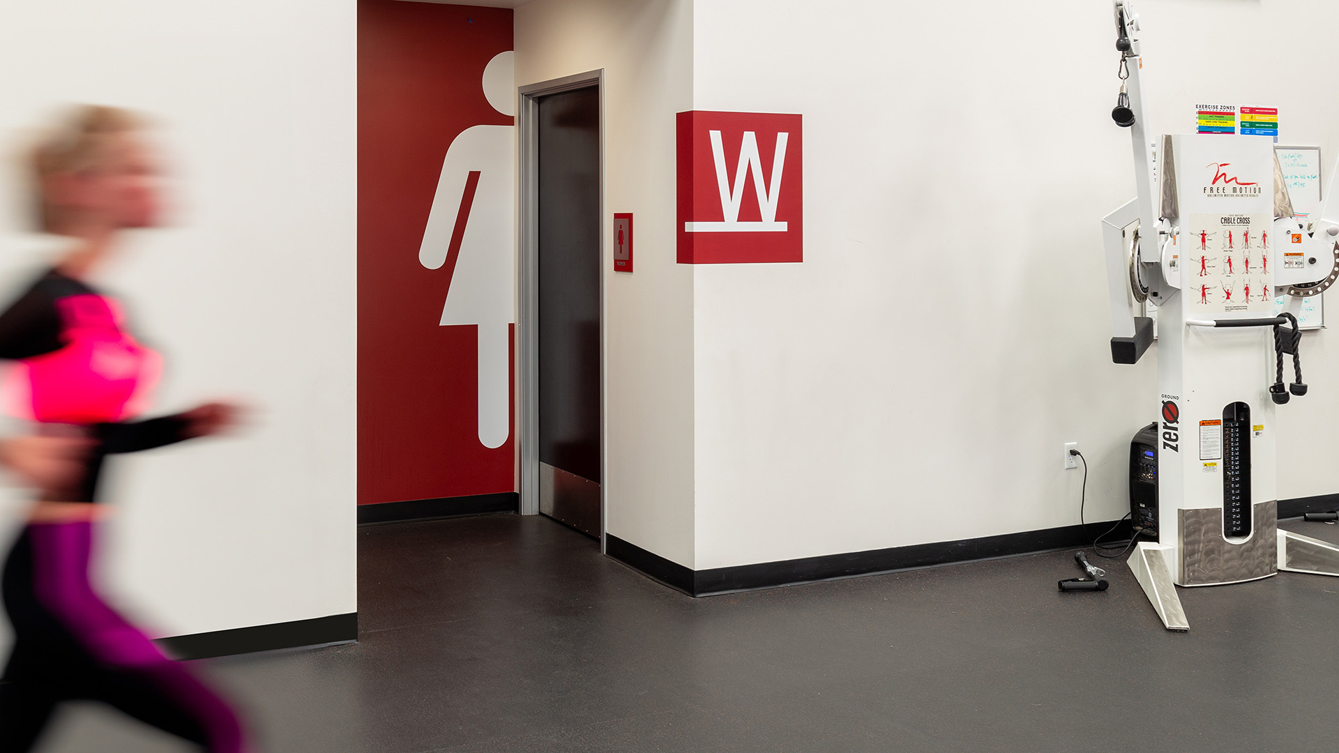 Large scale mens restroom graphics integrated into wall design in fitness area