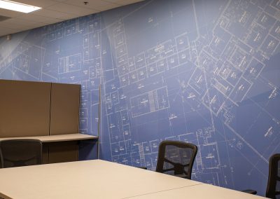 Large scale blueprint wall graphic in corporate war room at Caliente Construction office in Phoenix Arizona