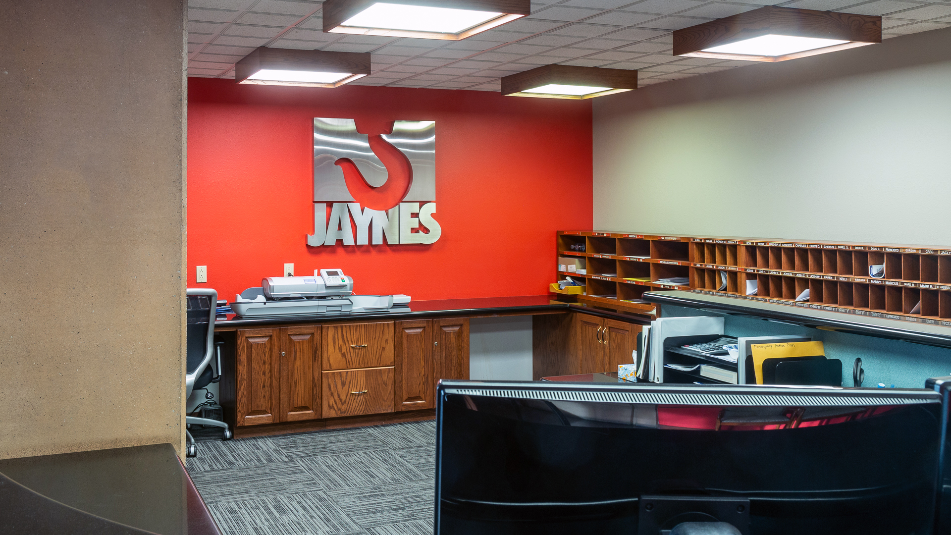 Corporate interior featuring fabricated channel letter logo mounted on branded wall behind reception area
