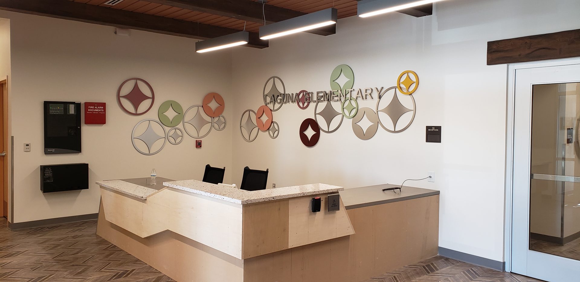 Laguna Elementary School lobby display with flat cut acrylic letters and metal laminated faces with painted symbols
