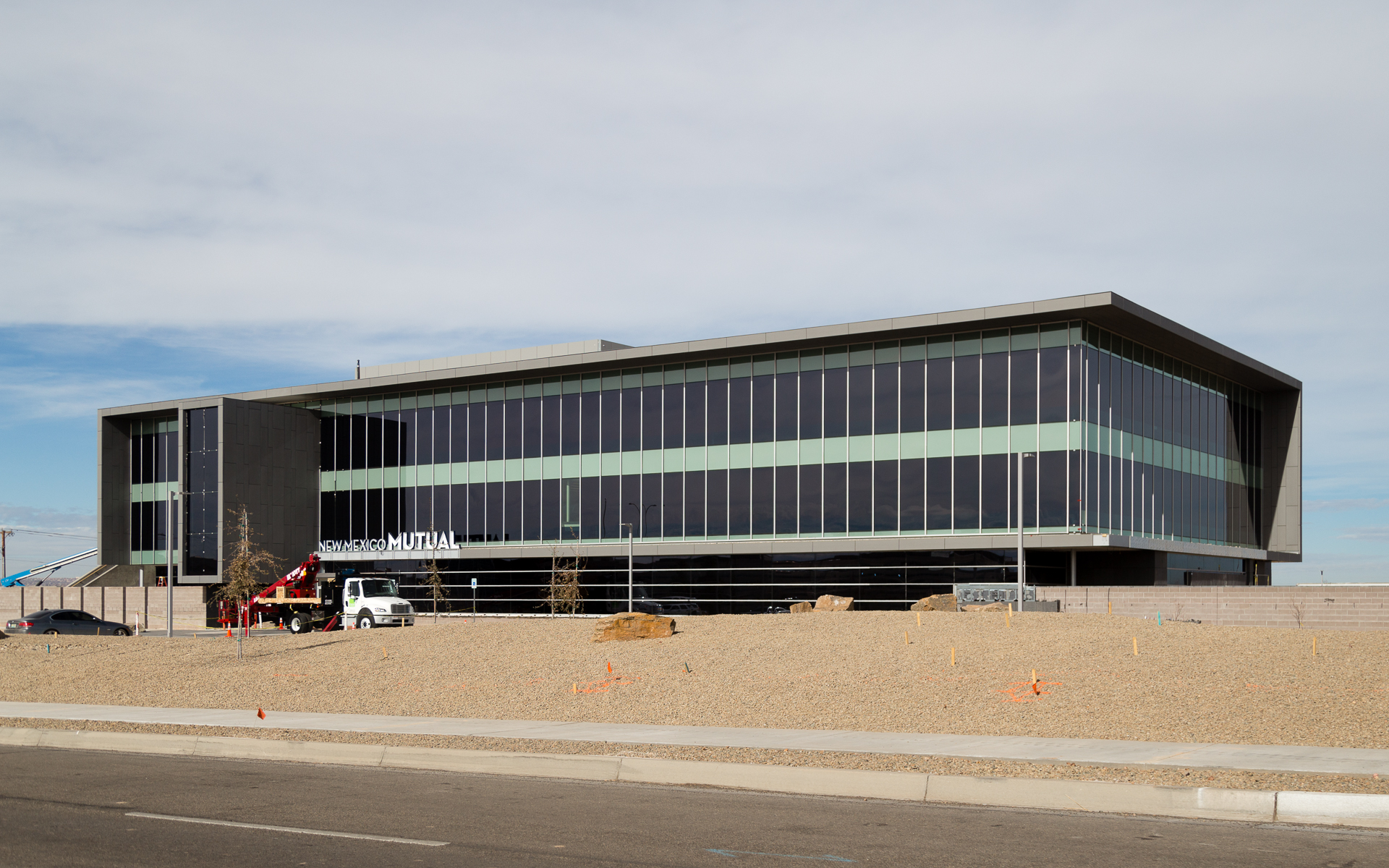 Wide daytime view of corporate building with bottom mounted channel letters New Mexico Mutual Albuquerque