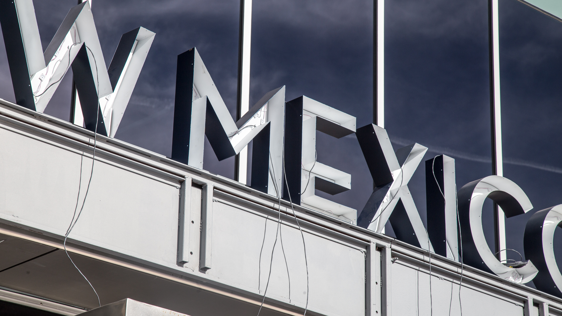 Installation of front face illuminated channel letters on New Mexico Mutual building exterior in Albuquerque