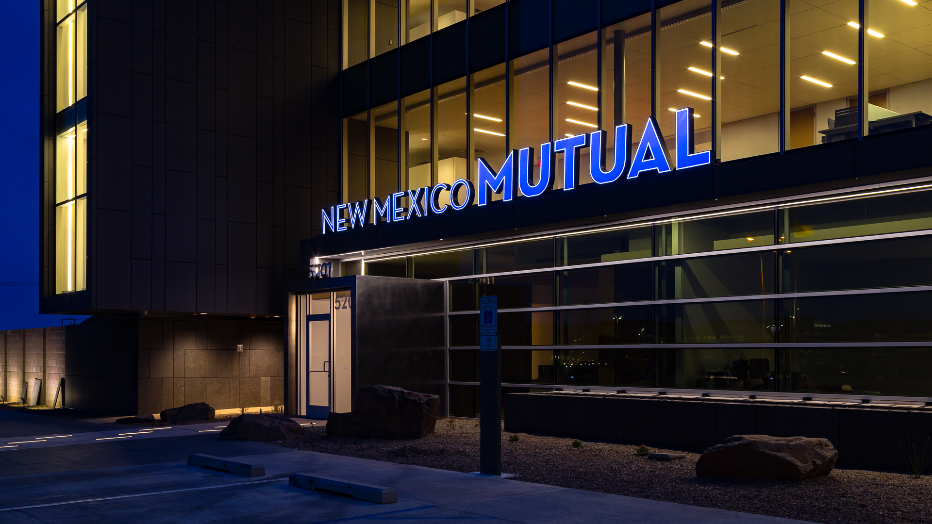 Close up of illuminated channel letters at night on corporate building New Mexico Mutual Albuquerque