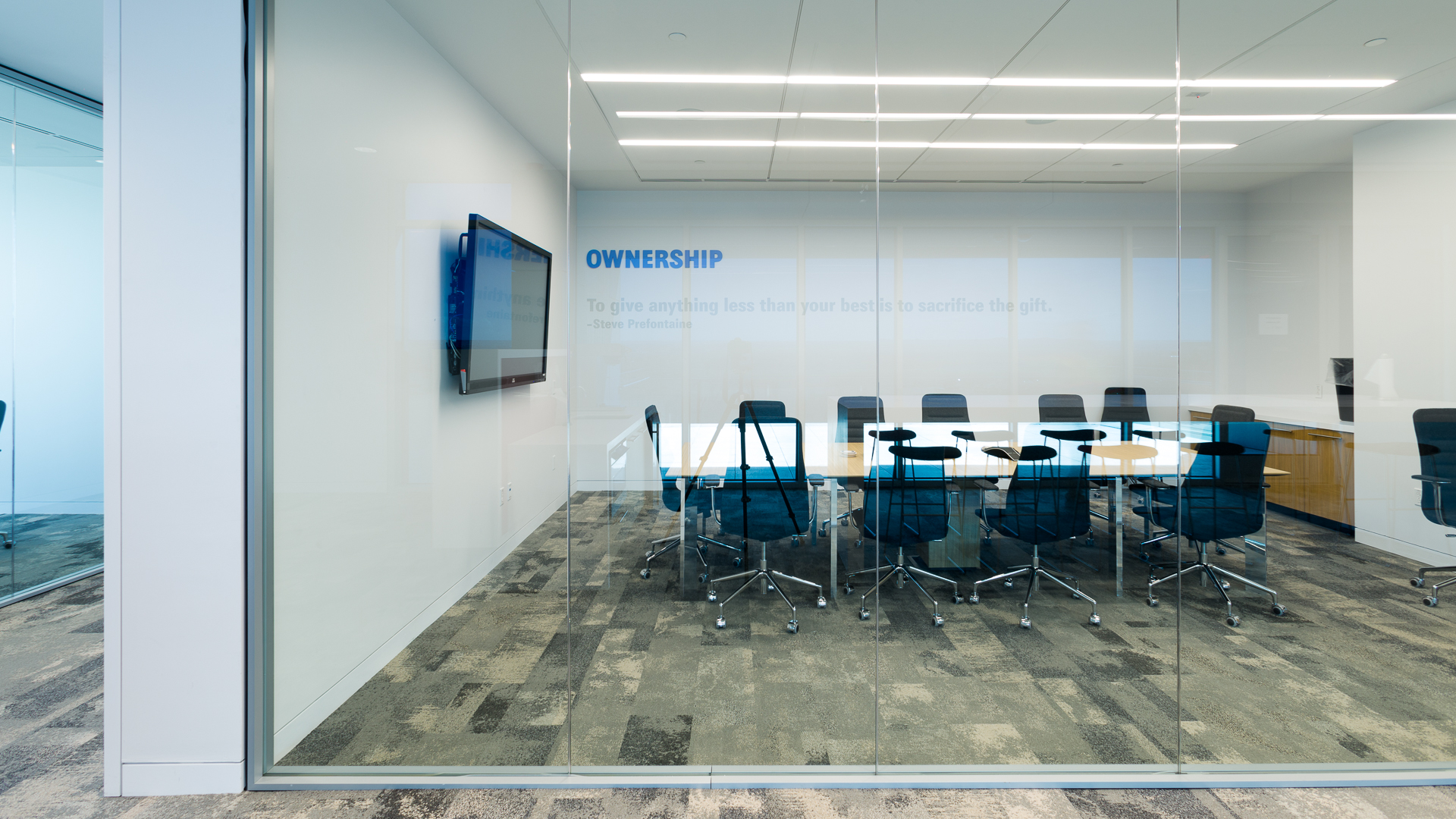 Conference room with glass wall graphics featuring ownership value message at New Mexico Mutual Albuquerque