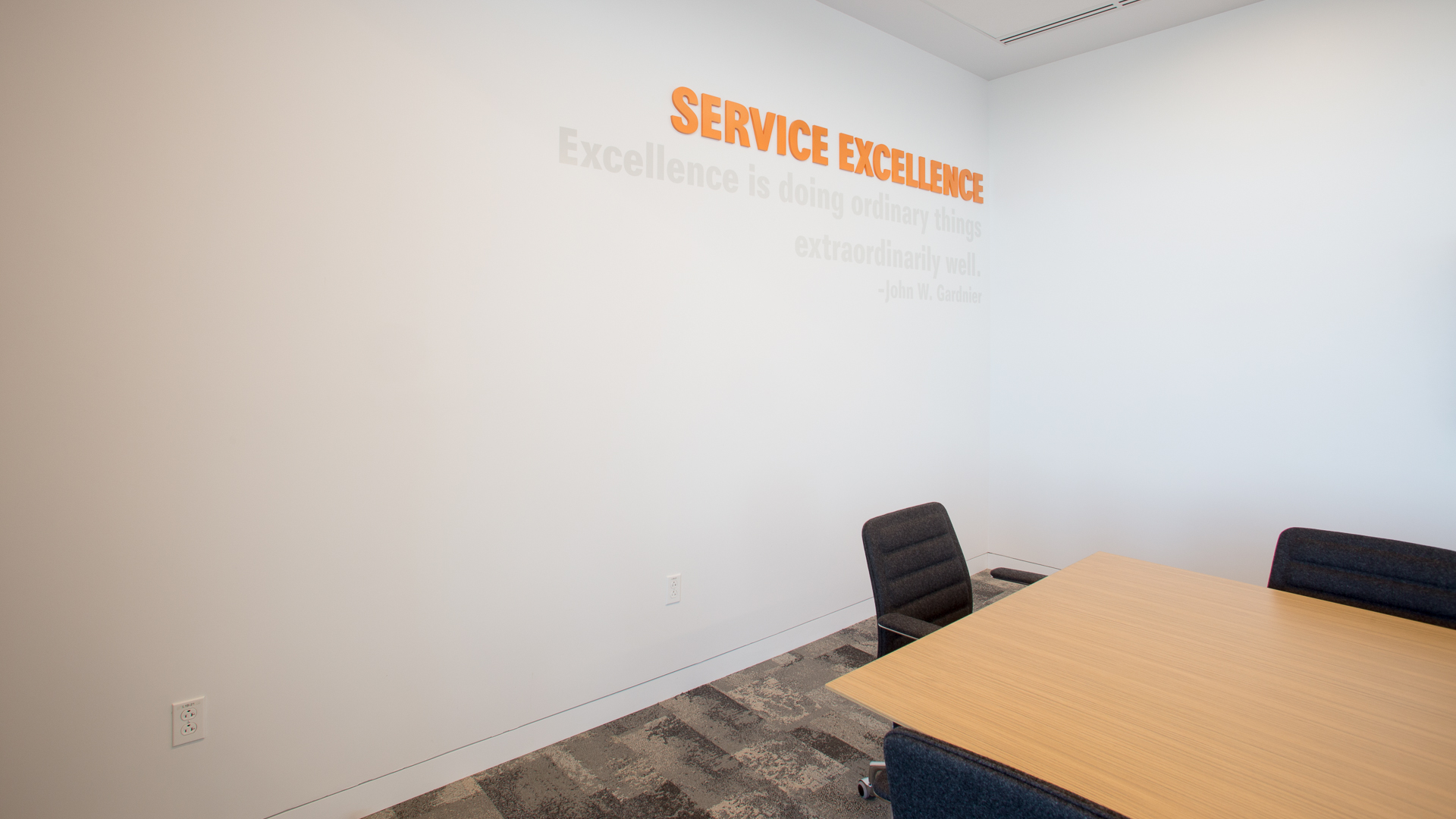 Service excellence dimensional letters with subtle vinyl quote graphics in conference room New Mexico Mutual Albuquerque