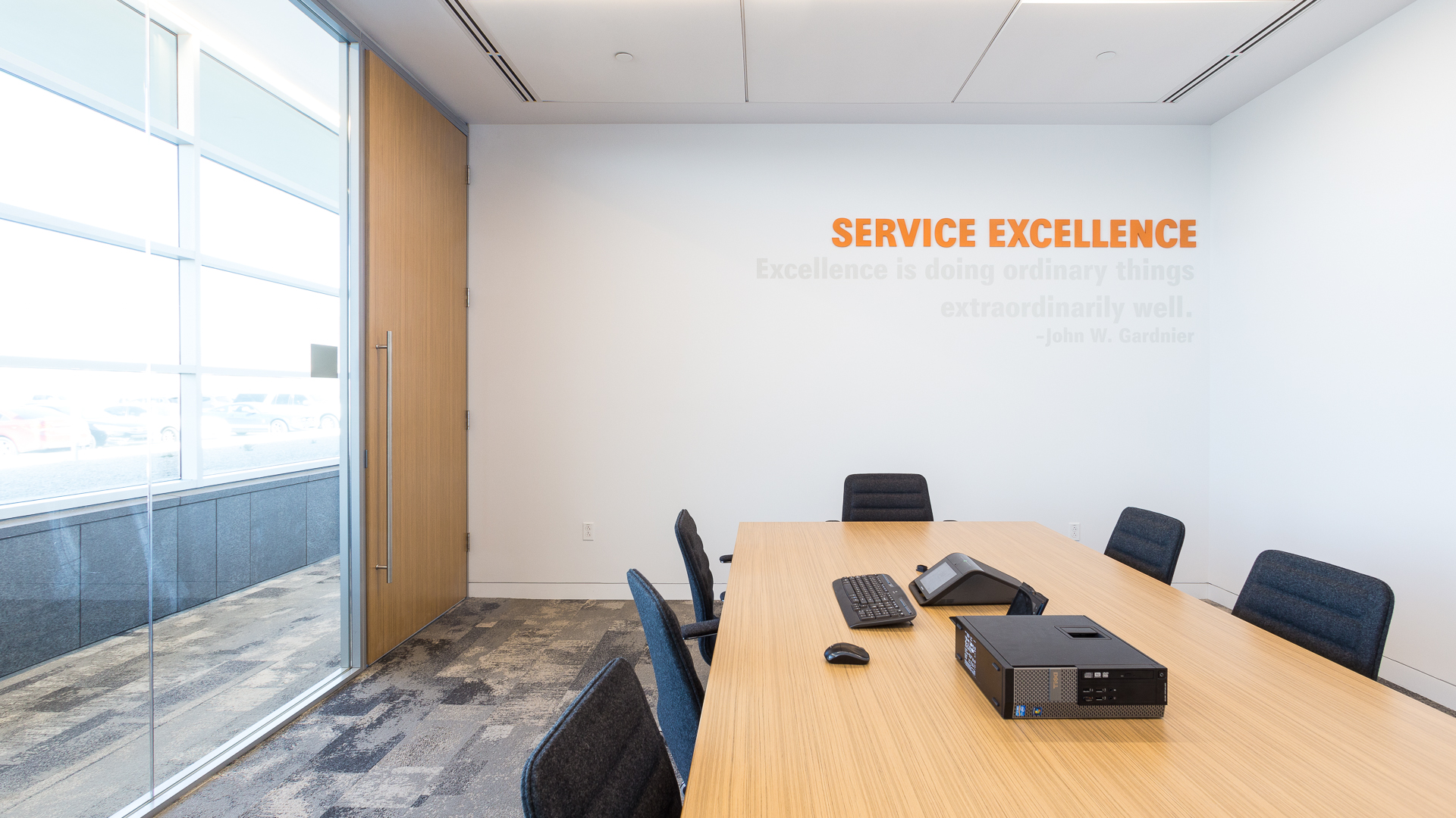Conference room wall with Service Excellence branding using dimensional acrylic letters and subtle vinyl graphics at New Mexico Mutual Albuquerque
