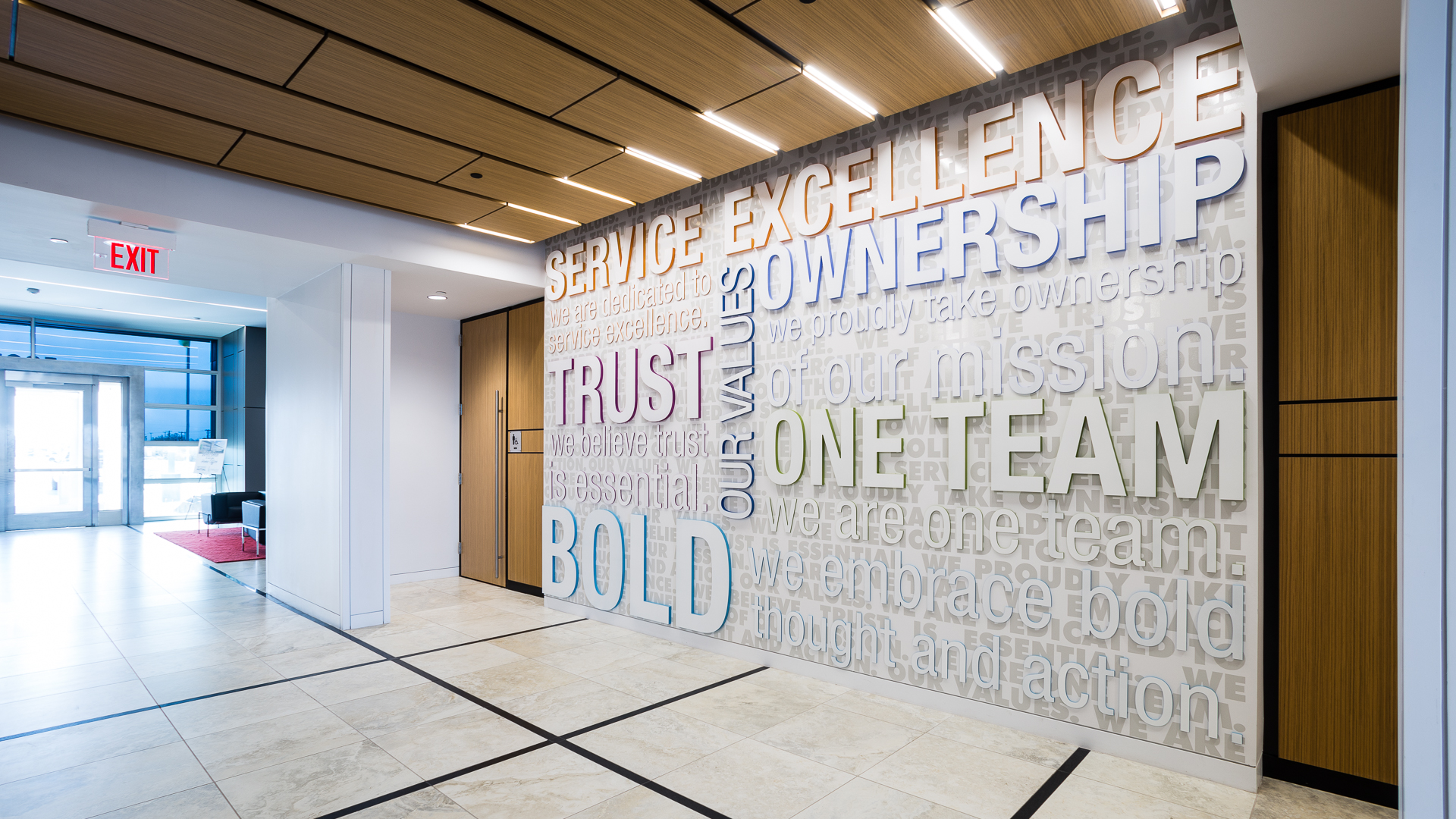 First floor lobby environmental graphics featuring values wall with dimensional acrylic letters at New Mexico Mutual in Albuquerque
