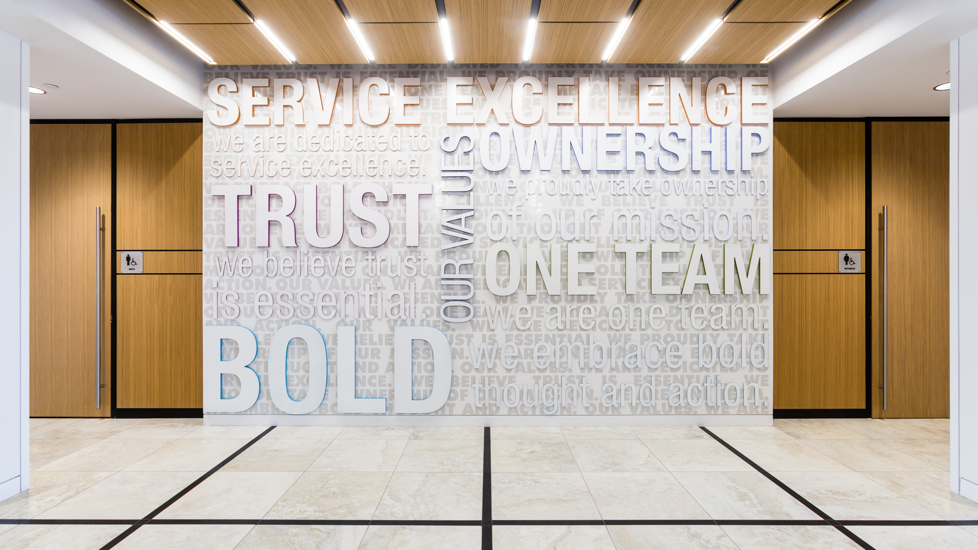 Interior environmental graphics values wall with dimensional lettering at New Mexico Mutual office in Albuquerque