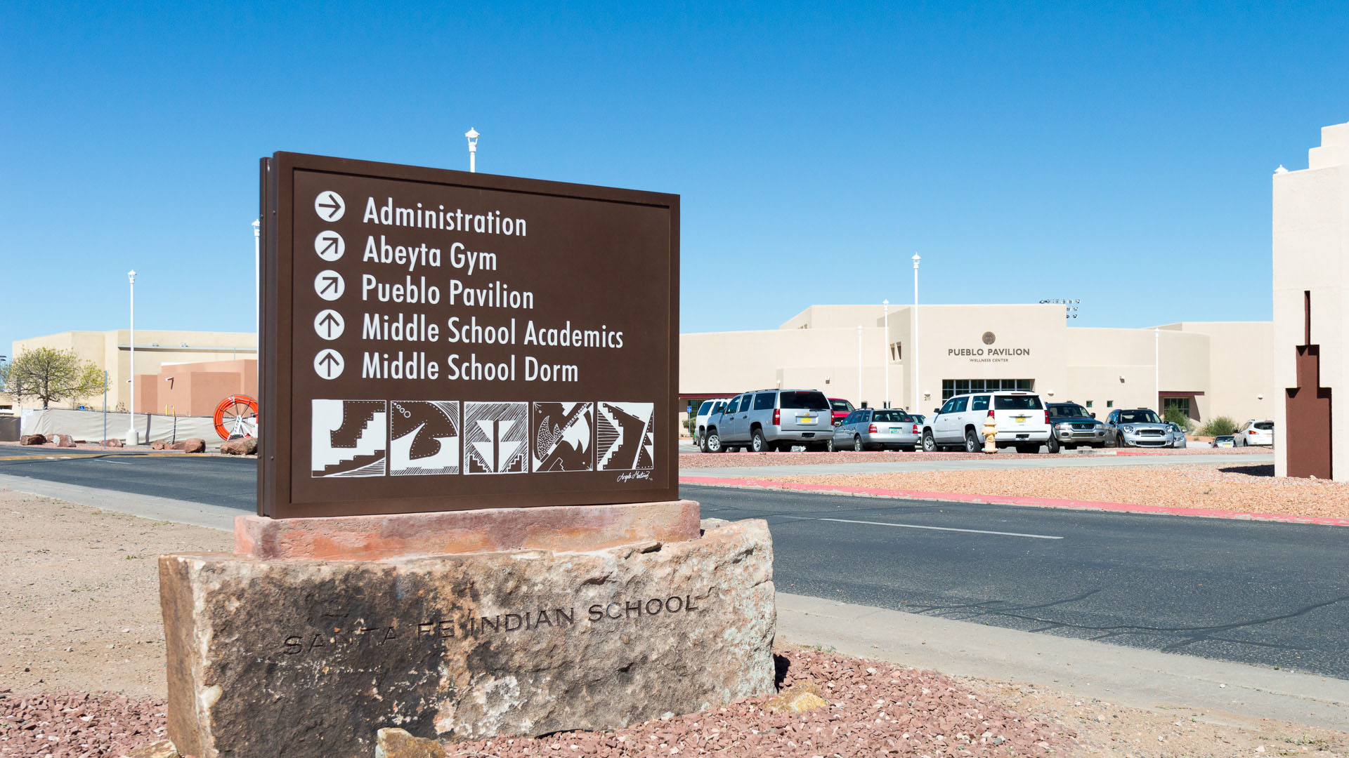 Santa Fe Indian School monument sign showing aluminum cabinet and stone base construction