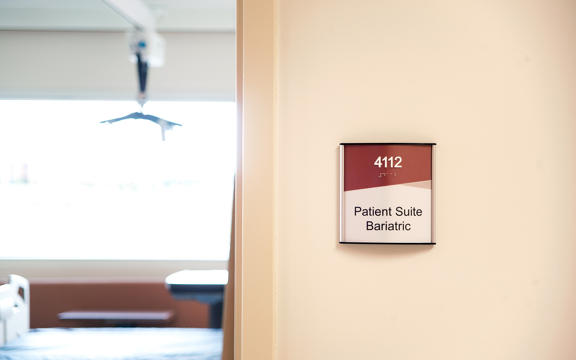 ADA room identification sign for patient suite with braille at UNM Sandoval Regional Medical Center