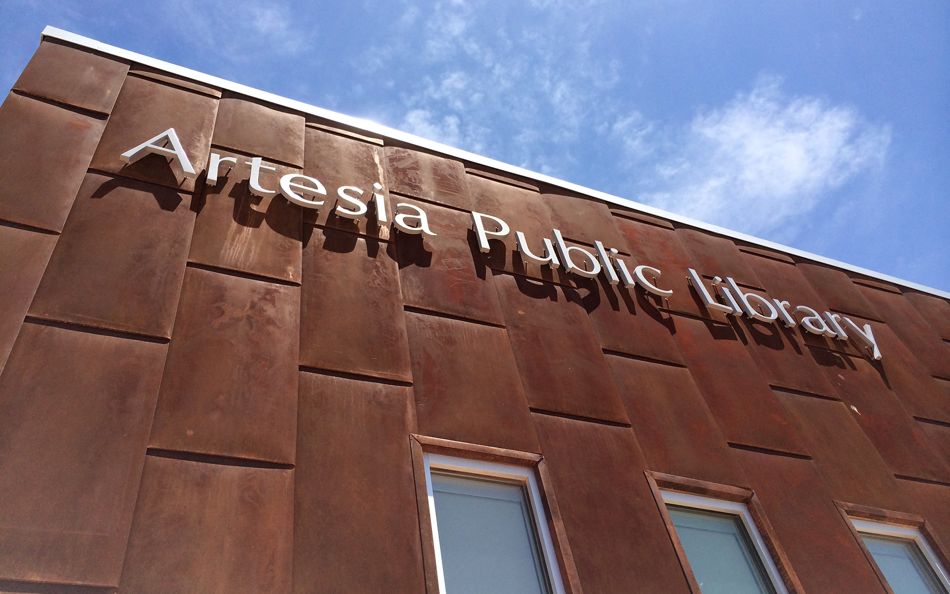 Exterior signage with flat cut aluminum letters identifying Artesia Public Library in New Mexico