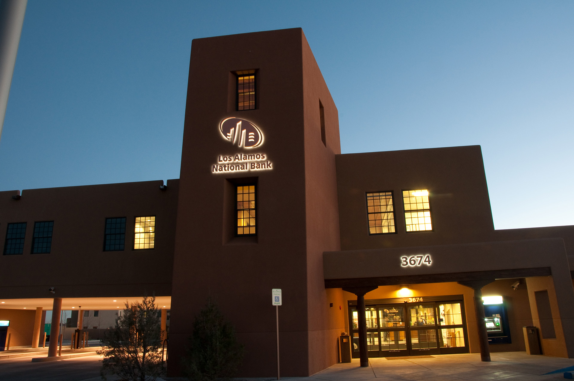 Night view of building identification wall mounted sign halo illumination