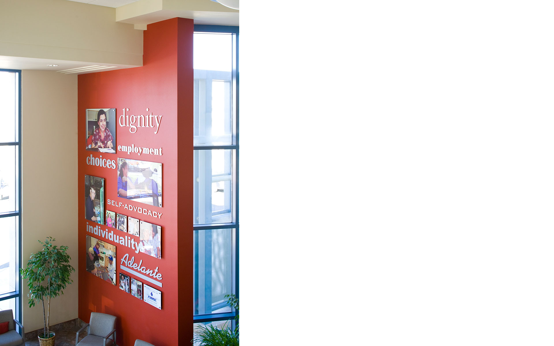 Acrylic mission statement display with flat cut dimensional letters and integrated photo wall graphics