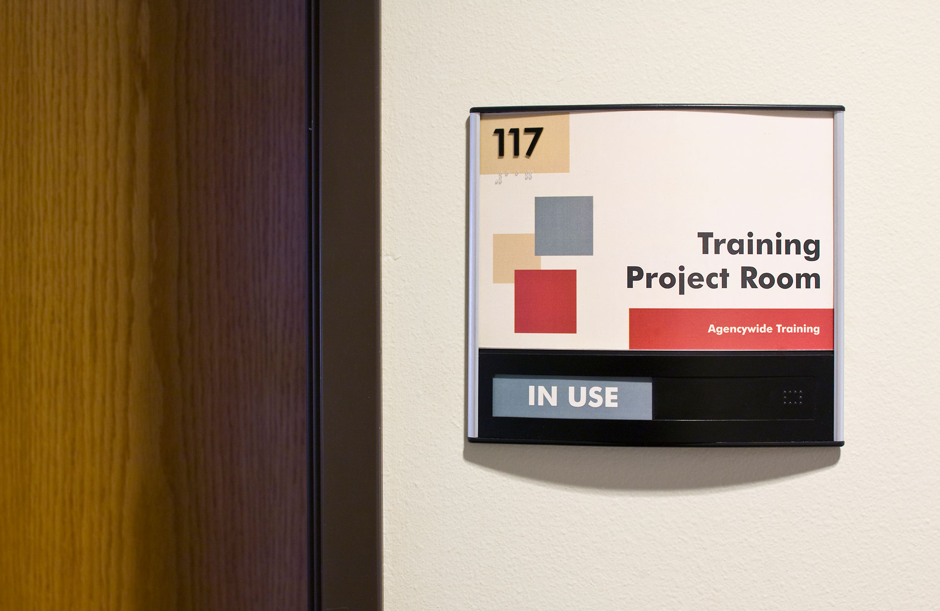 Interior ADA room sign with slider component showing room availability status