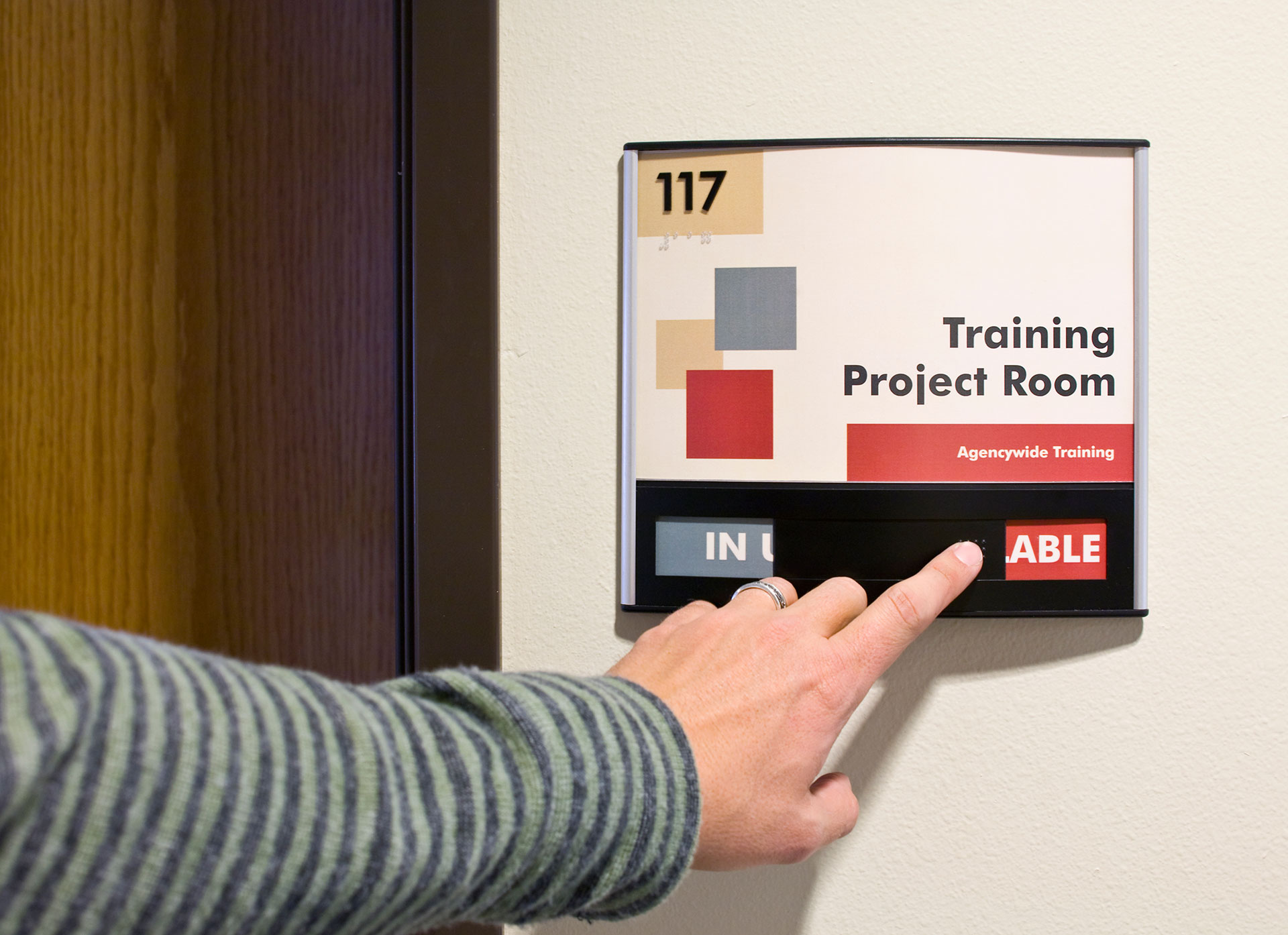 Close-up of ADA room sign with slider indicating available or in use