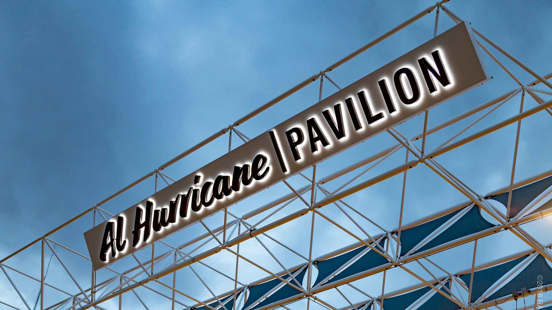 Close up of halo lit reverse channel letters with LED illumination on custom sign cabinet system