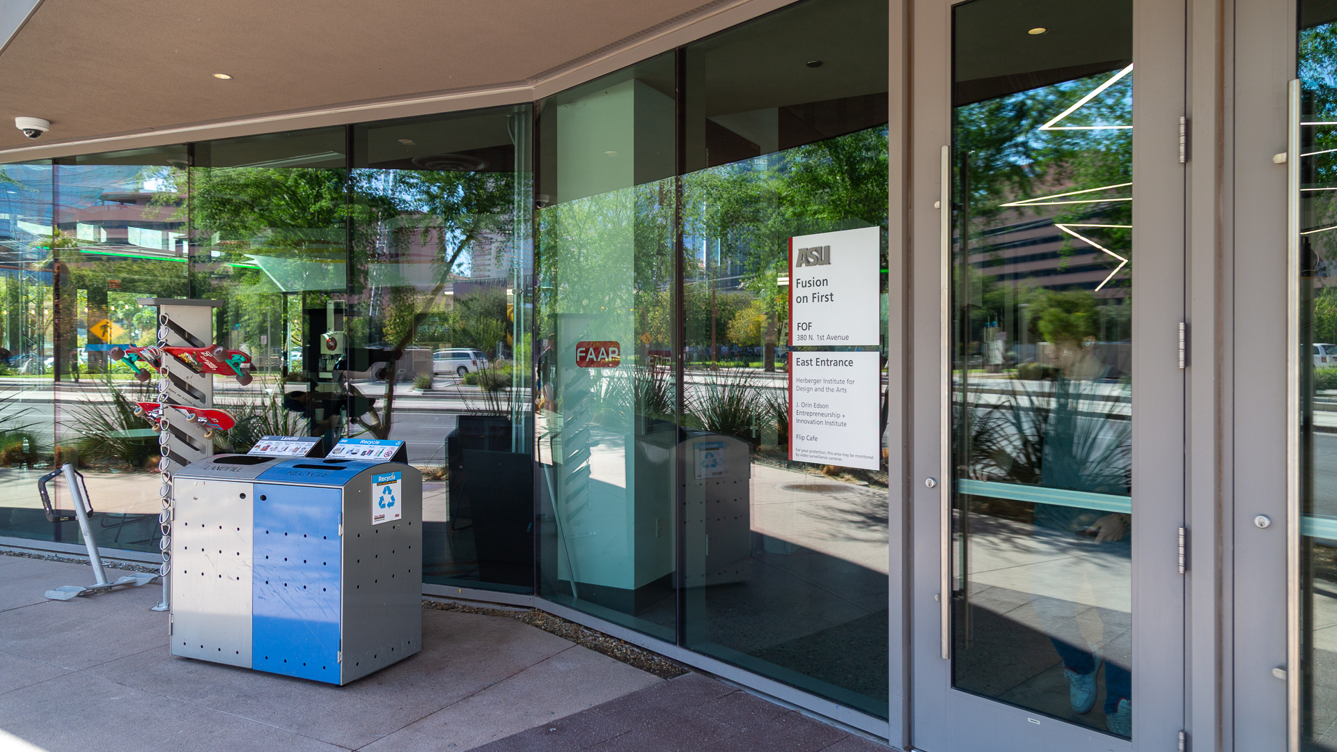 Glass-mounted wayfinding sign at ASU Fusion on First east entrance showing building identification and tenant listings