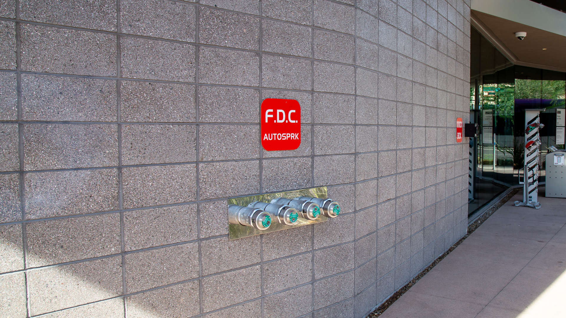 Fire department connection FDC sign and standpipe connections on exterior wall at ASU Fusion on First