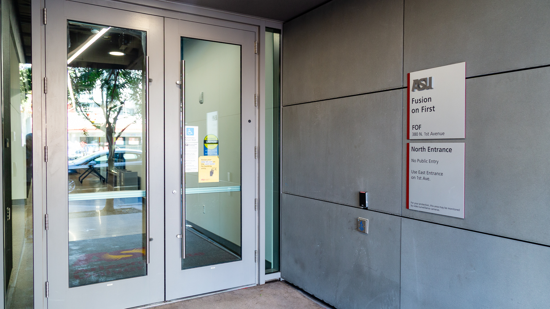 Directional sign at ASU Fusion on First north entrance indicating restricted access and directing visitors to east entrance
