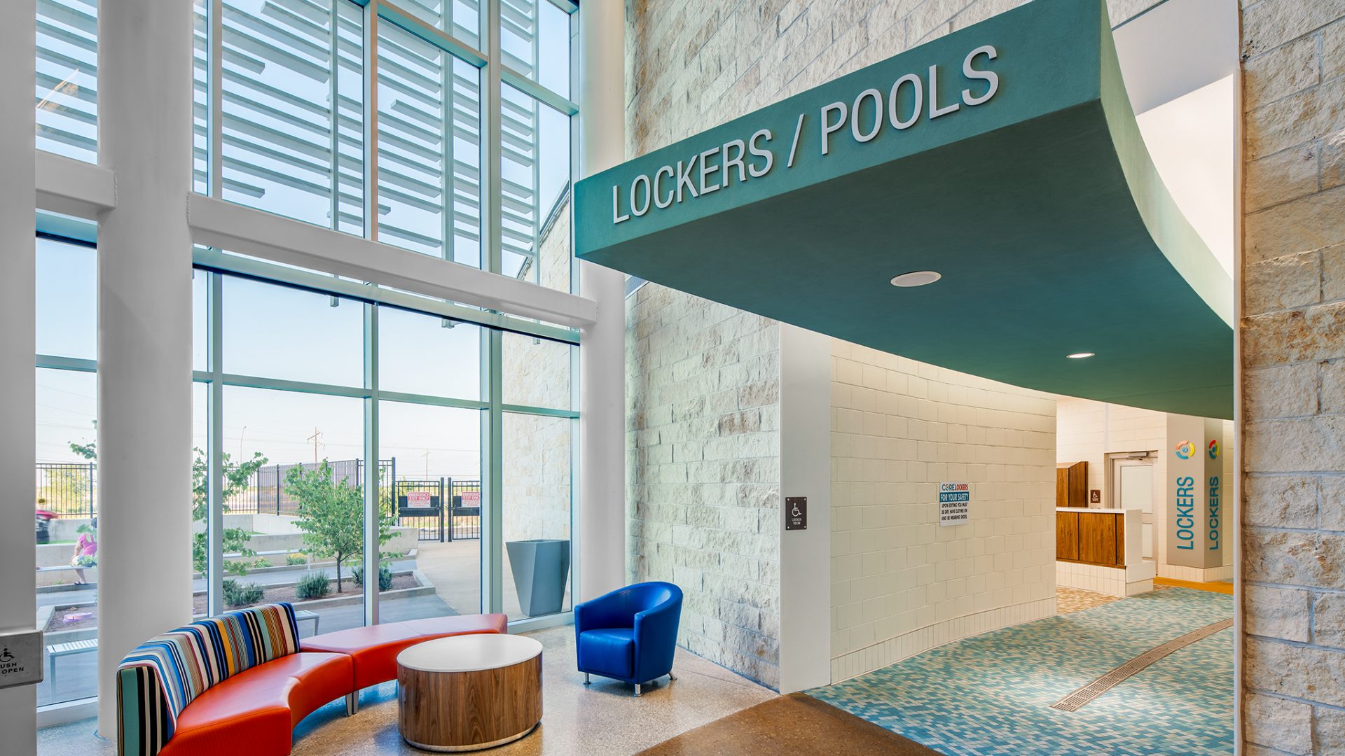 Flat cut acrylic lettering used for locker room and pool signage at recreation center by professional sign company