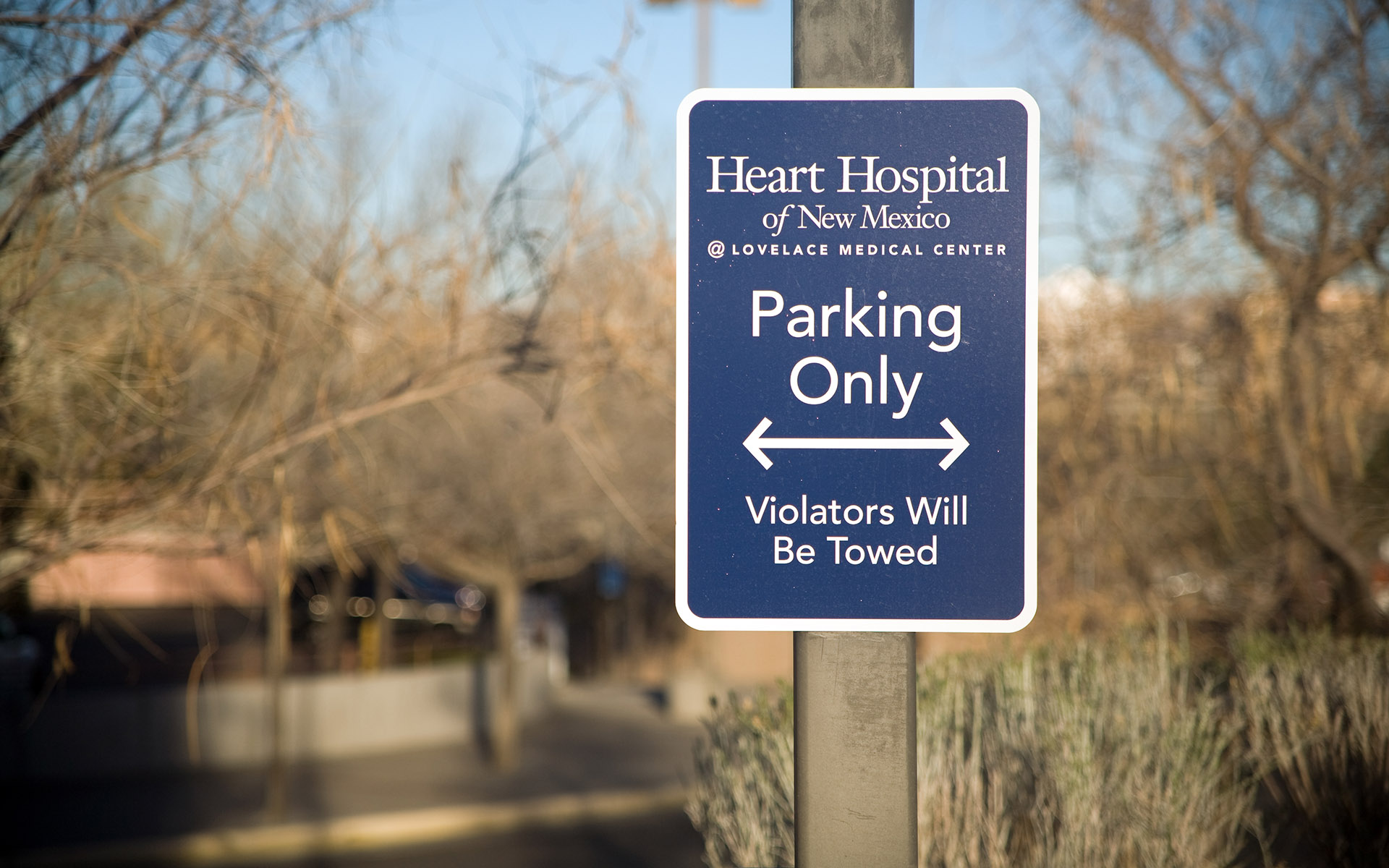 Exterior parking sign mounted on post at Heart Hospital of New Mexico