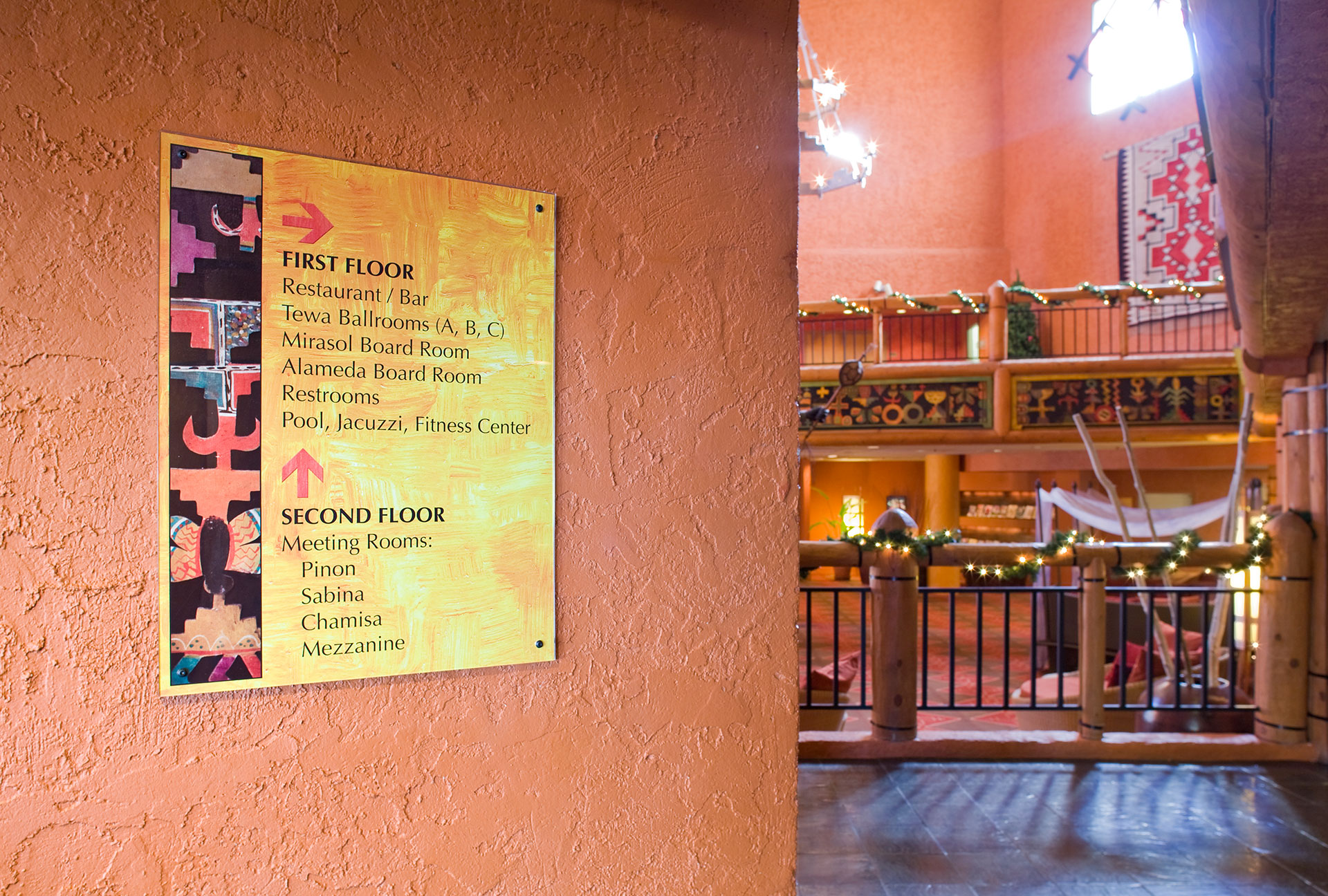 Hotel interior directory sign showing first and second floor amenities with custom textured panel