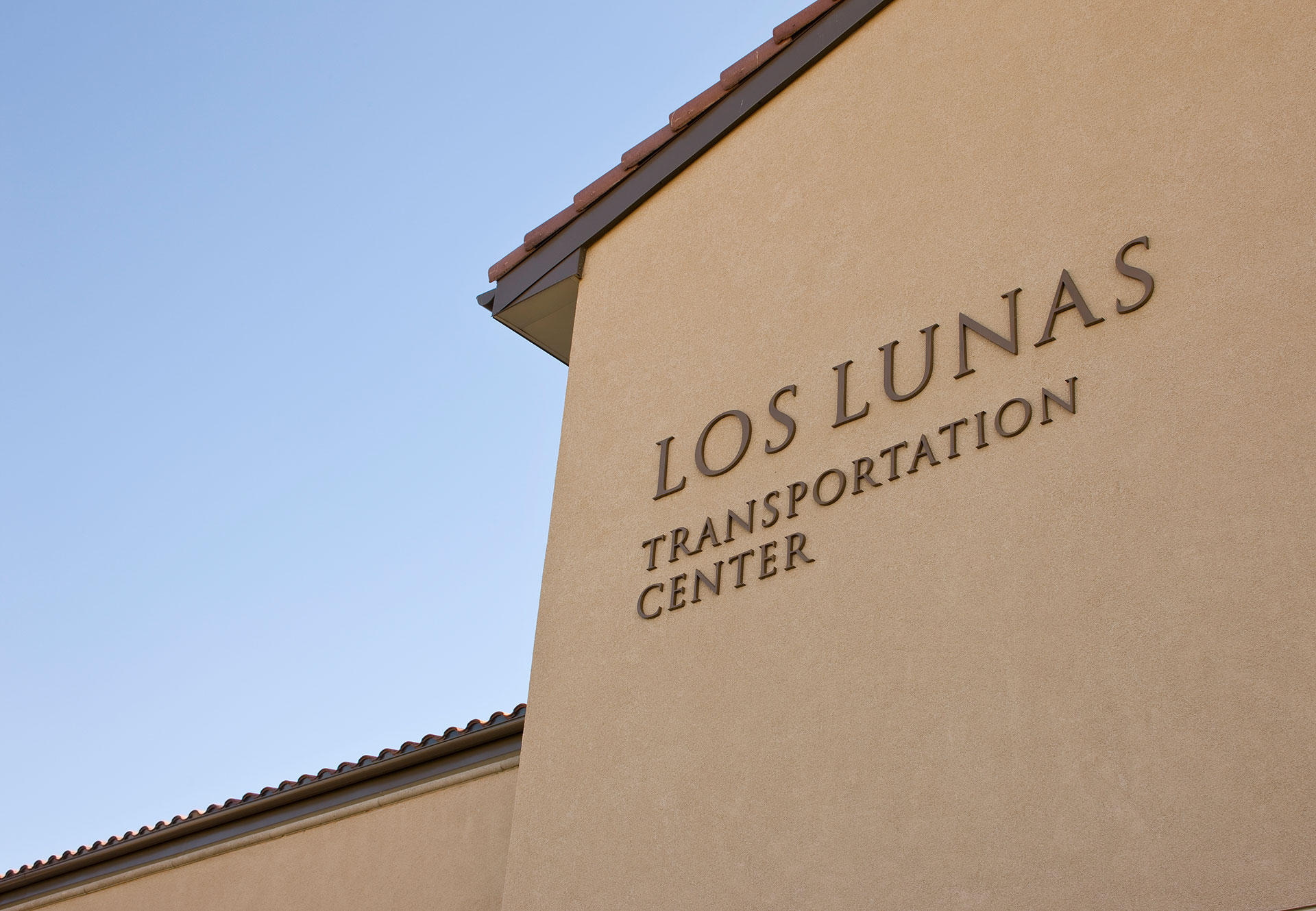Formed plastic dimensional letters on exterior wall at Los Lunas Transportation Center