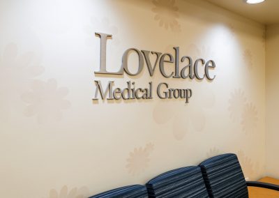 Lovelace Medical Group lobby with flat cut aluminum logo signage on branded wall