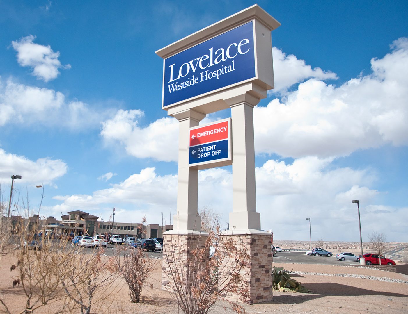 Large freestanding pylon sign identifying Lovelace Westside Hospital and directing emergency and patient drop off