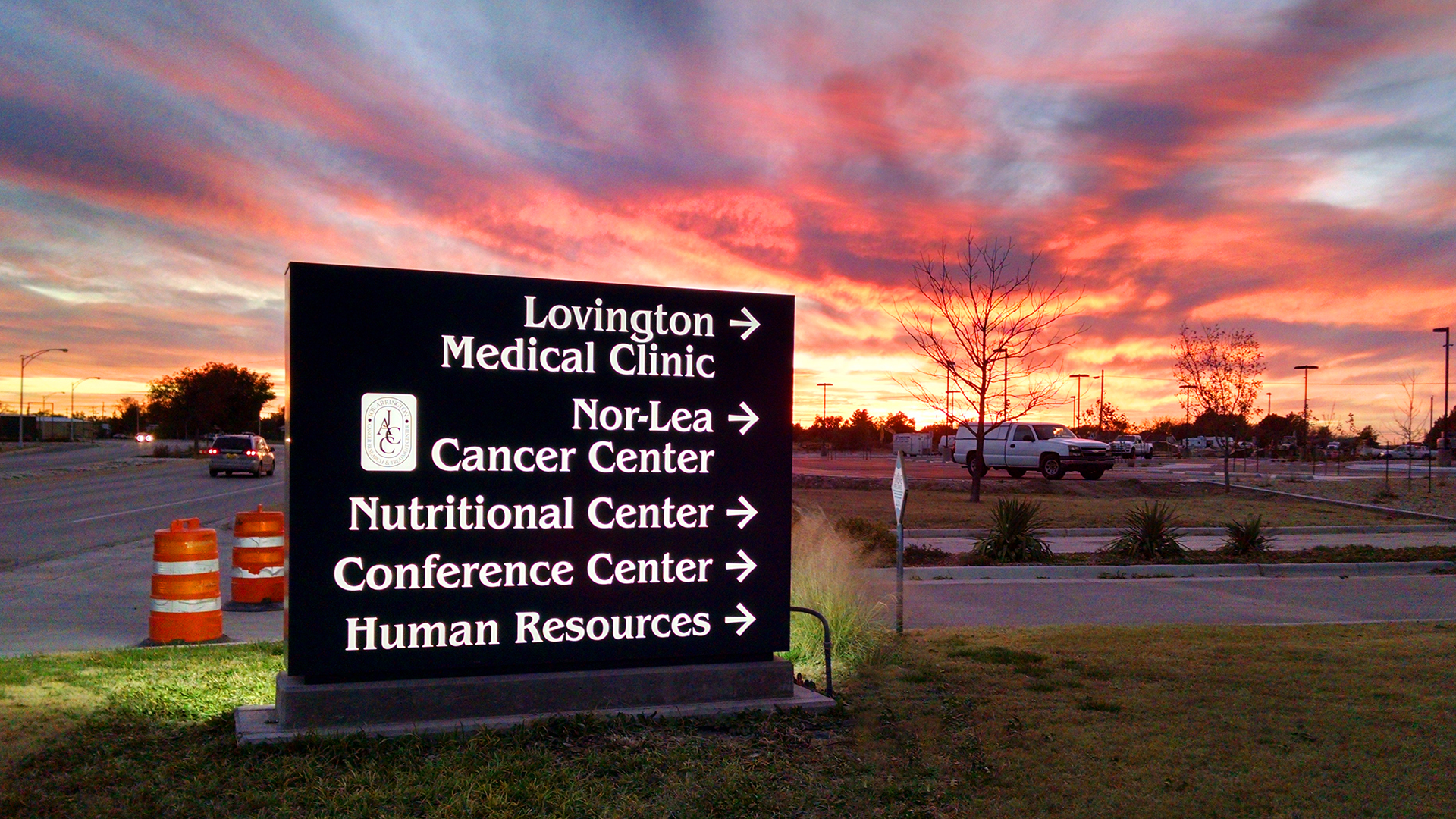 Exterior illuminated hospital wayfinding sign at night directing visitors to medical facilities at Nor Lea Hospital District