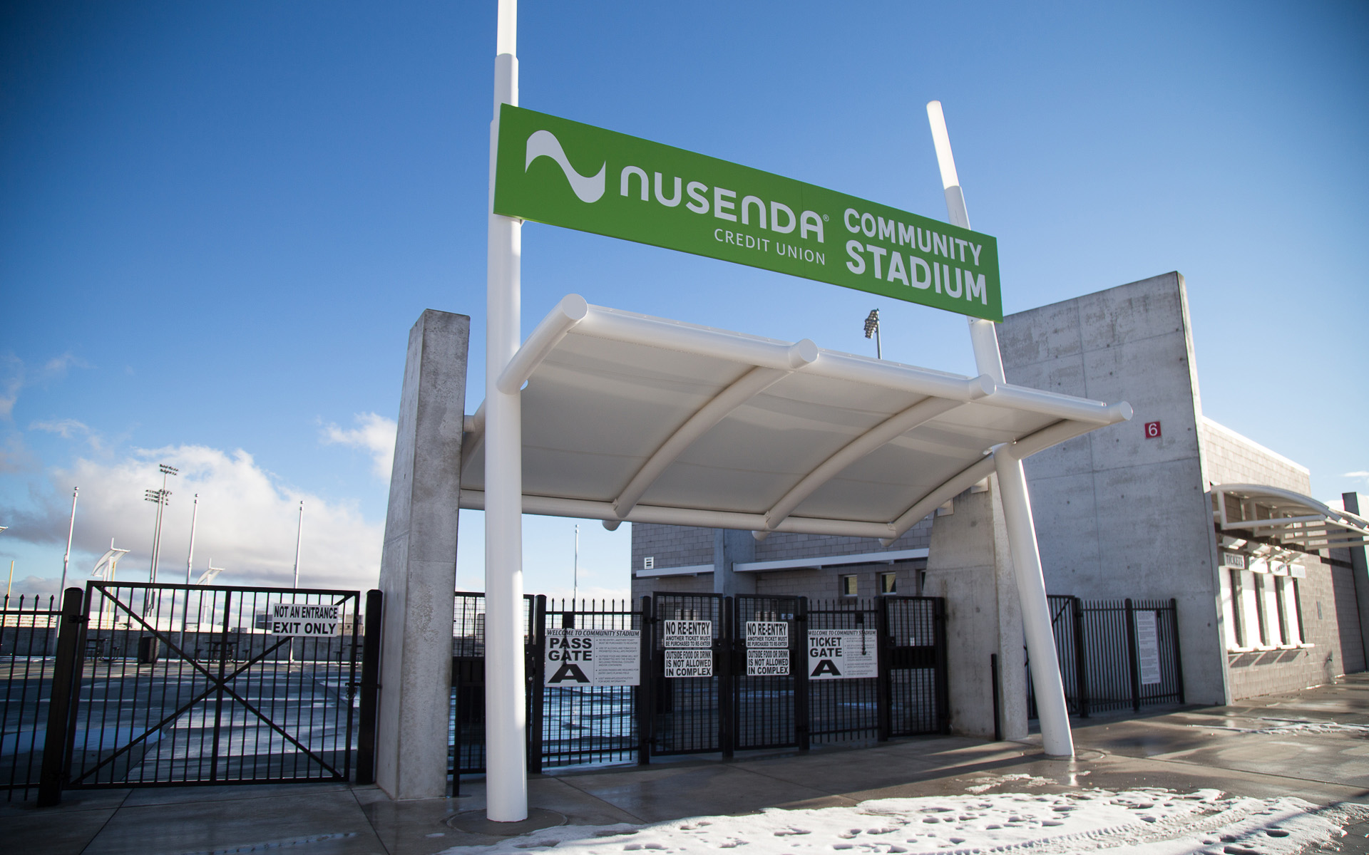 Nusenda Community Stadium entry sign mounted above canopy structure at main entrance