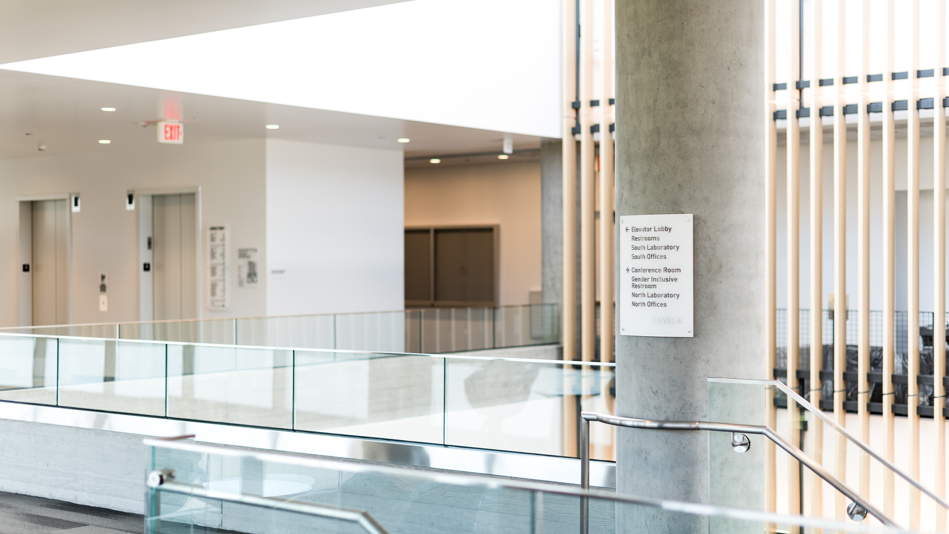 Acrylic directional sign mounted to column guiding users to rooms and amenities at UC Riverside