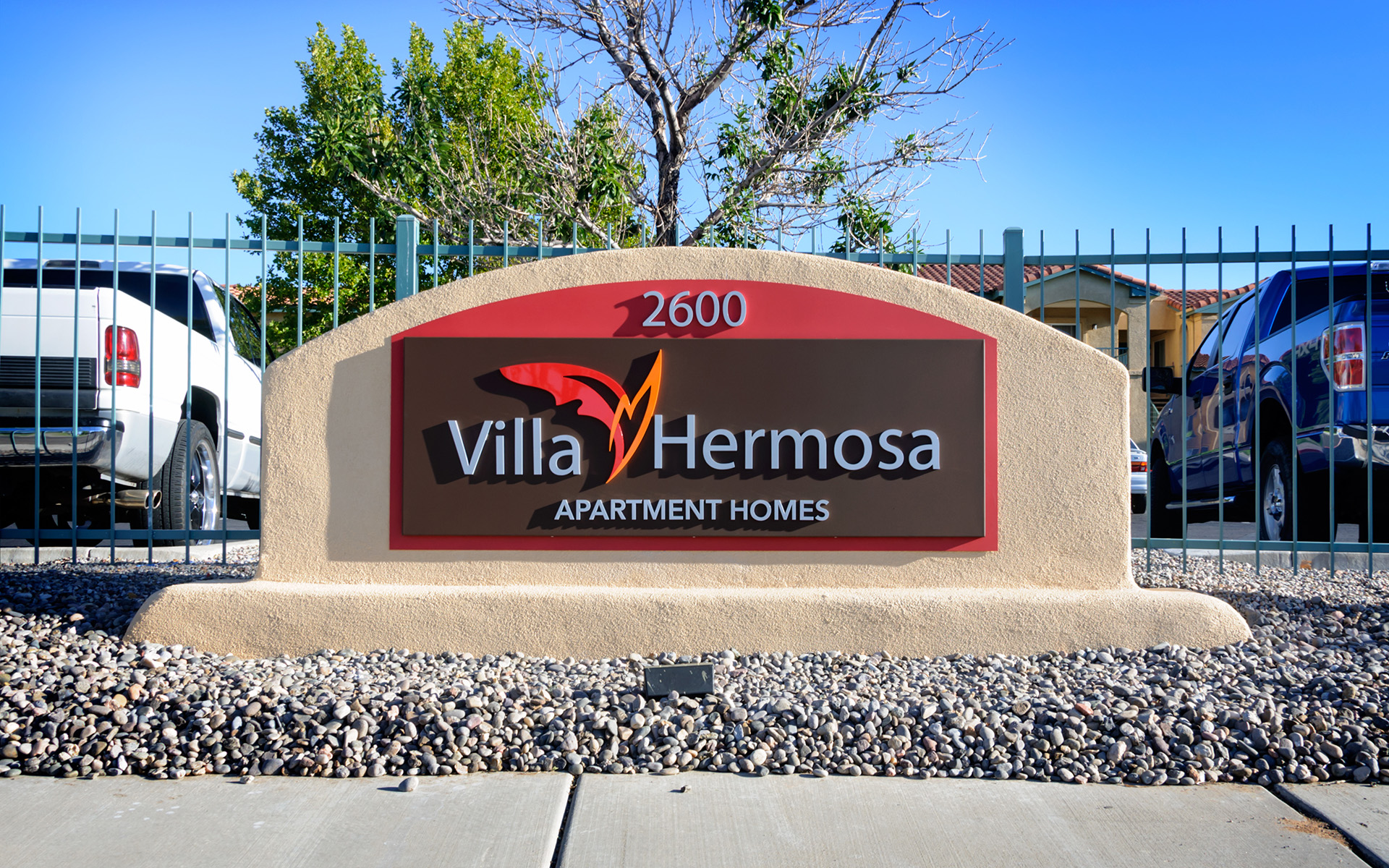 Wide view of monument sign with address and surrounding site context