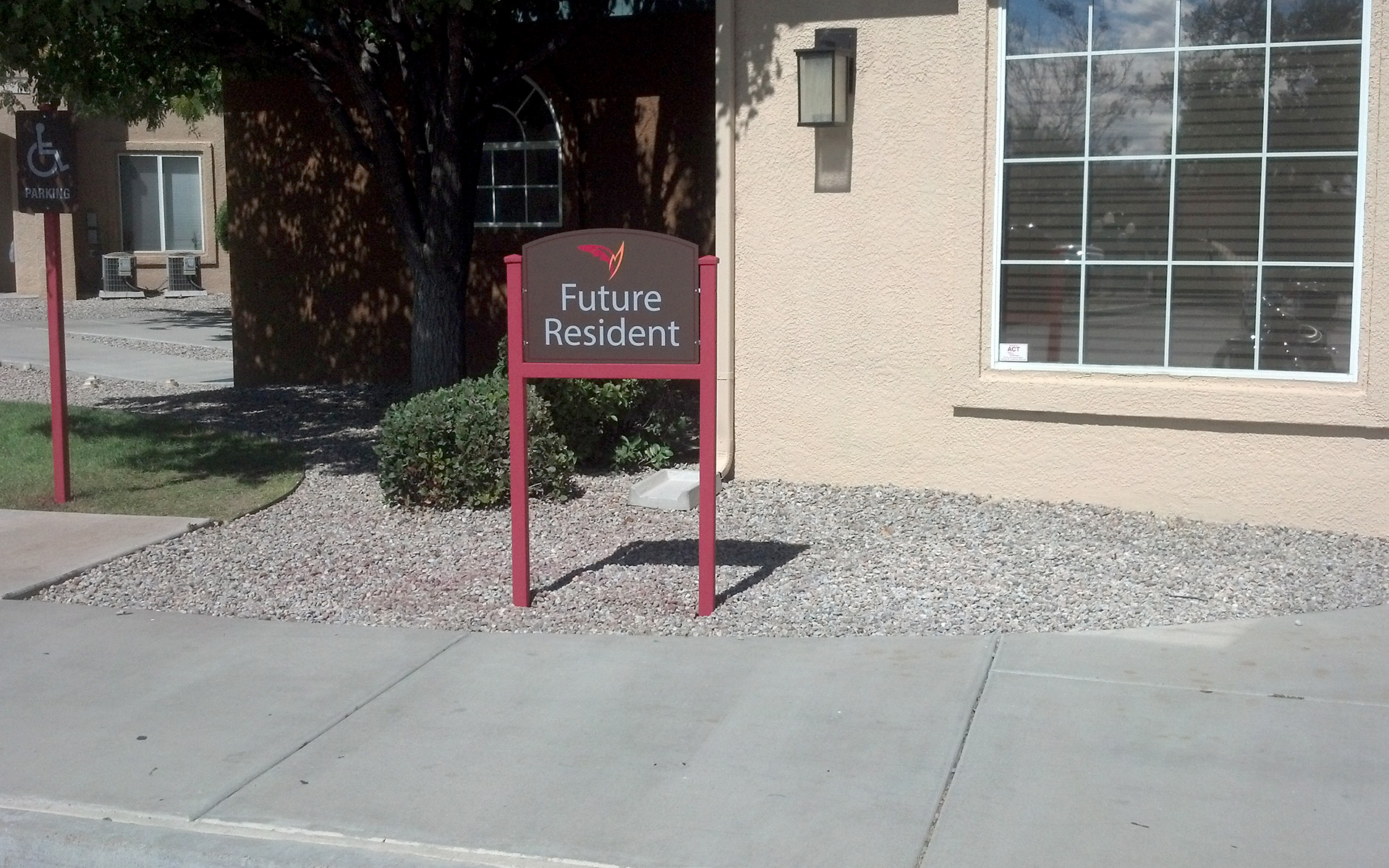 Directional sign guiding visitors to leasing office and future resident parking area