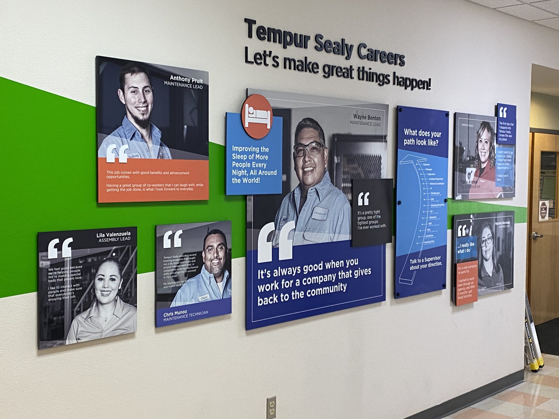 Environmental graphic wall with employee photos, quotes, and branded panels promoting Tempur Sealy careers and workplace culture.