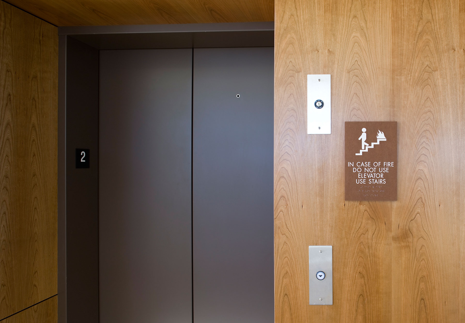 ADA compliant fire safety sign with tactile lettering and braille