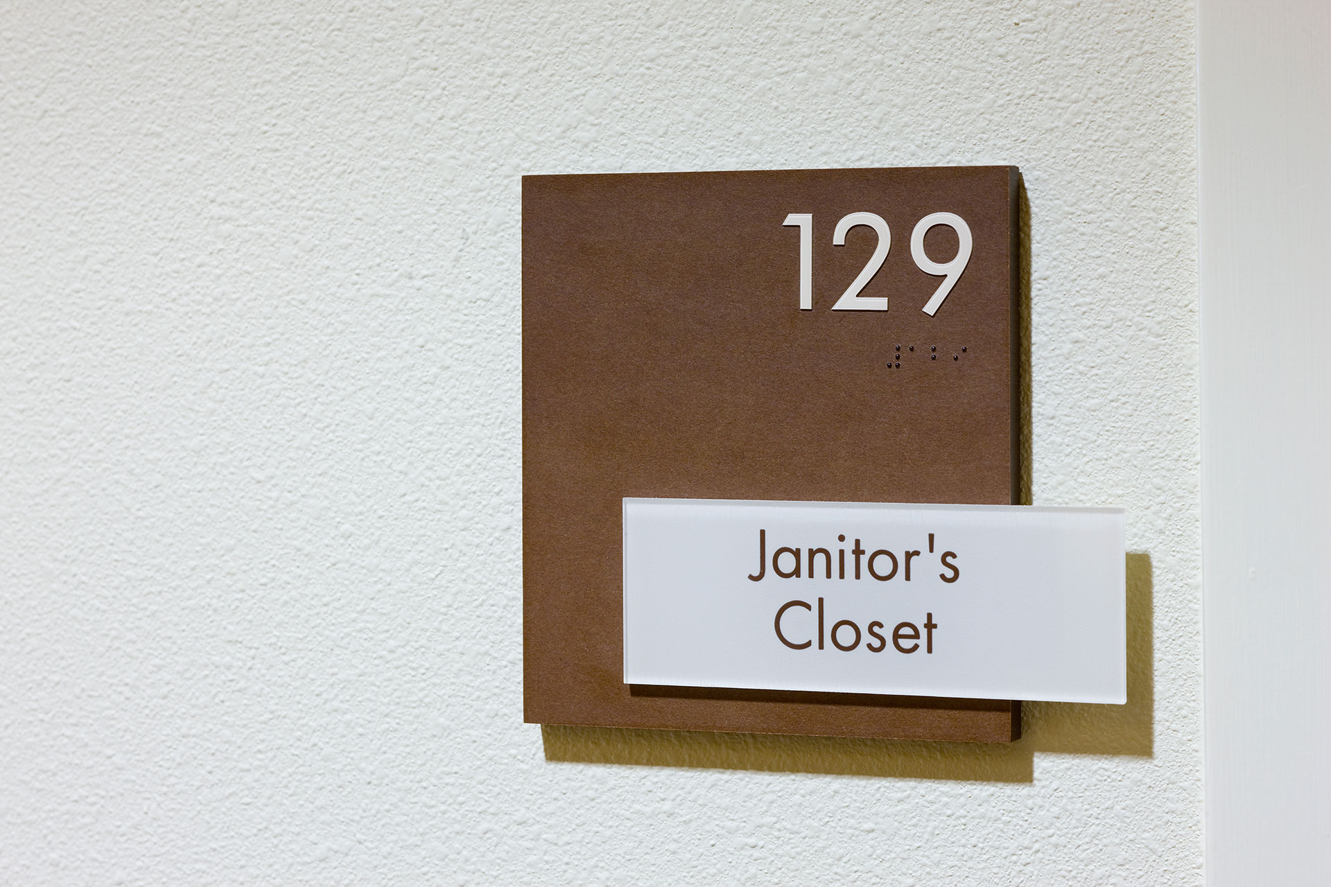ADA compliant room sign with braille and tactile lettering