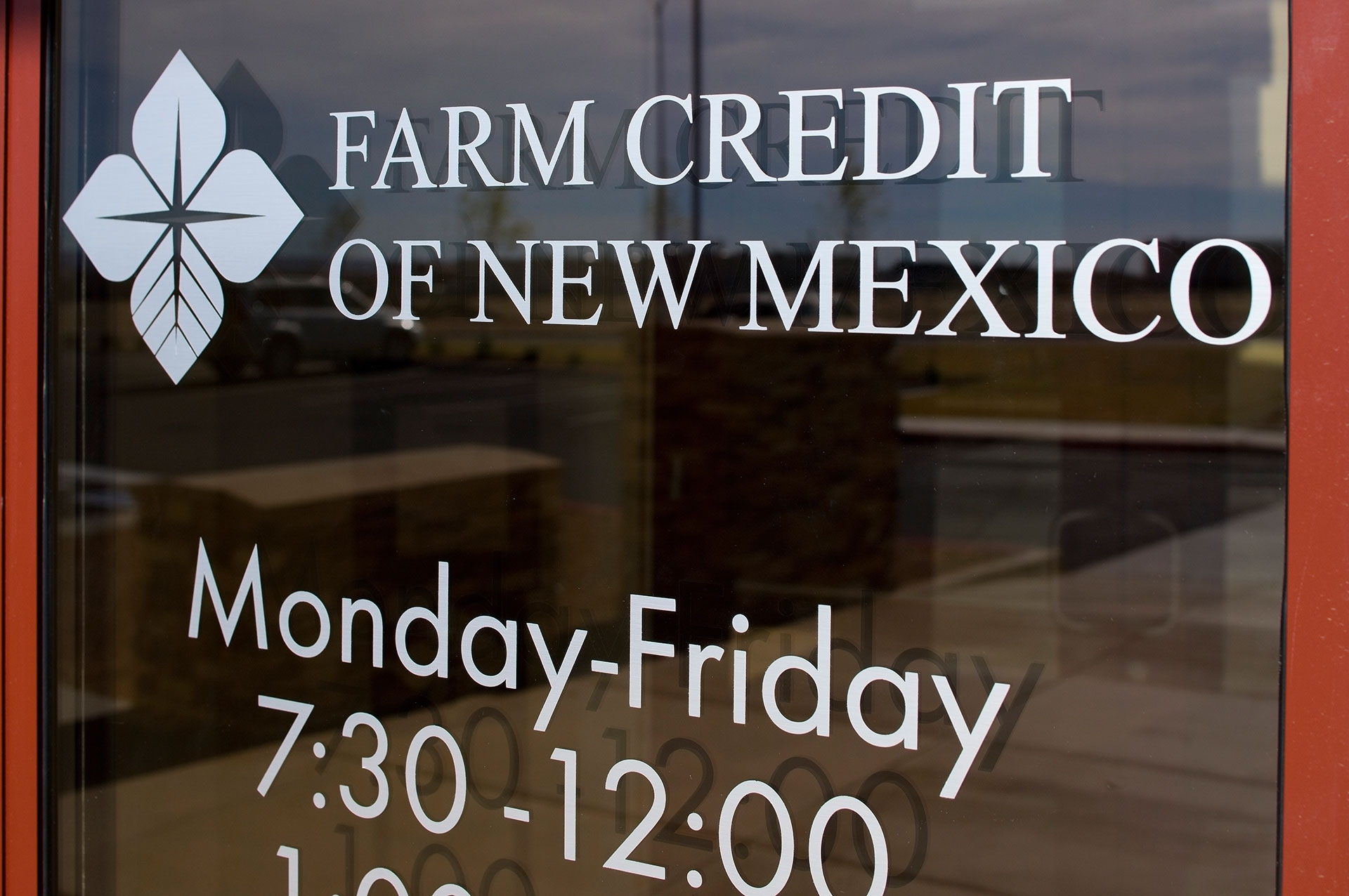 Brushed aluminum vinyl lettering applied to glass storefront