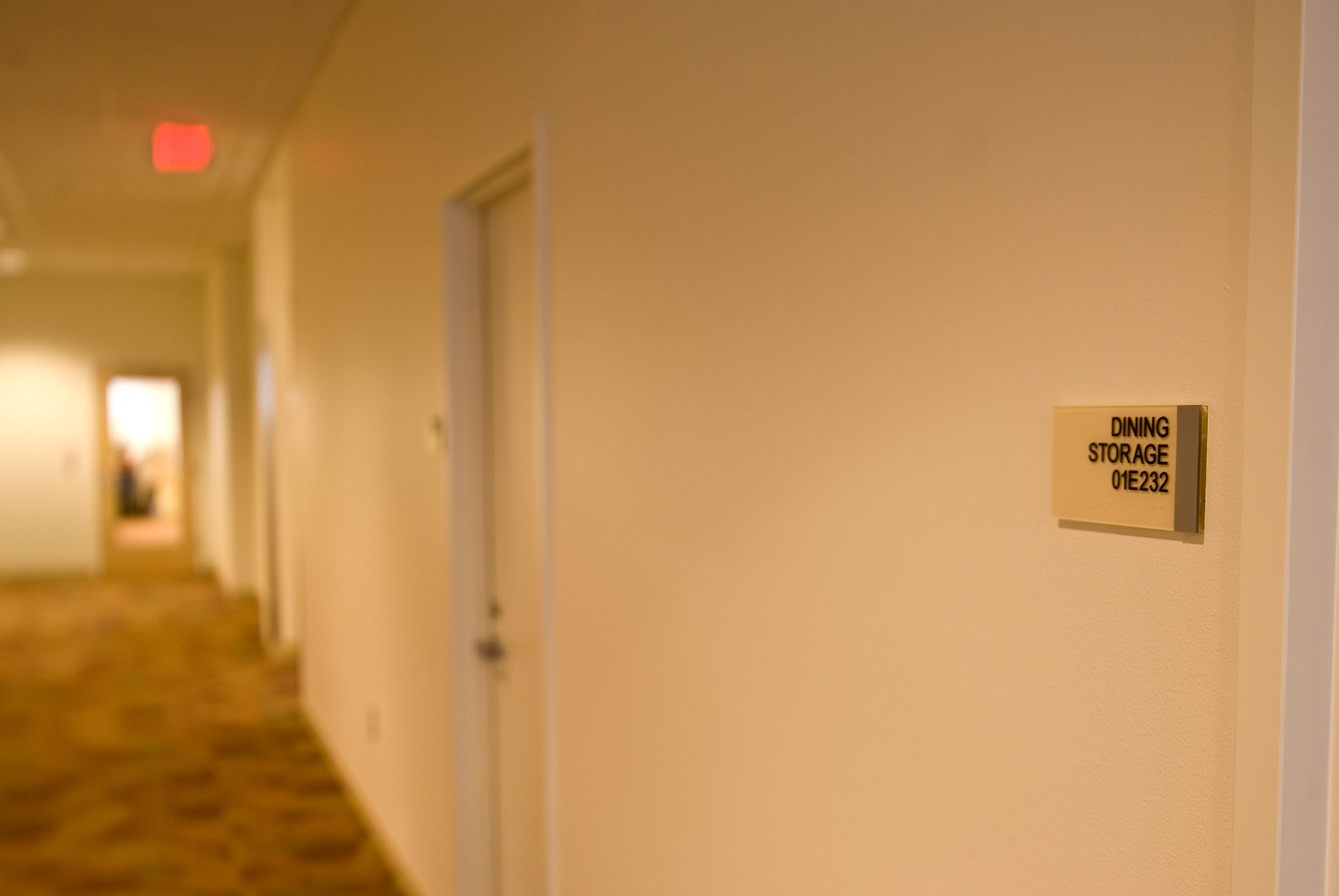 Interior ADA room sign with tactile lettering and braille identification