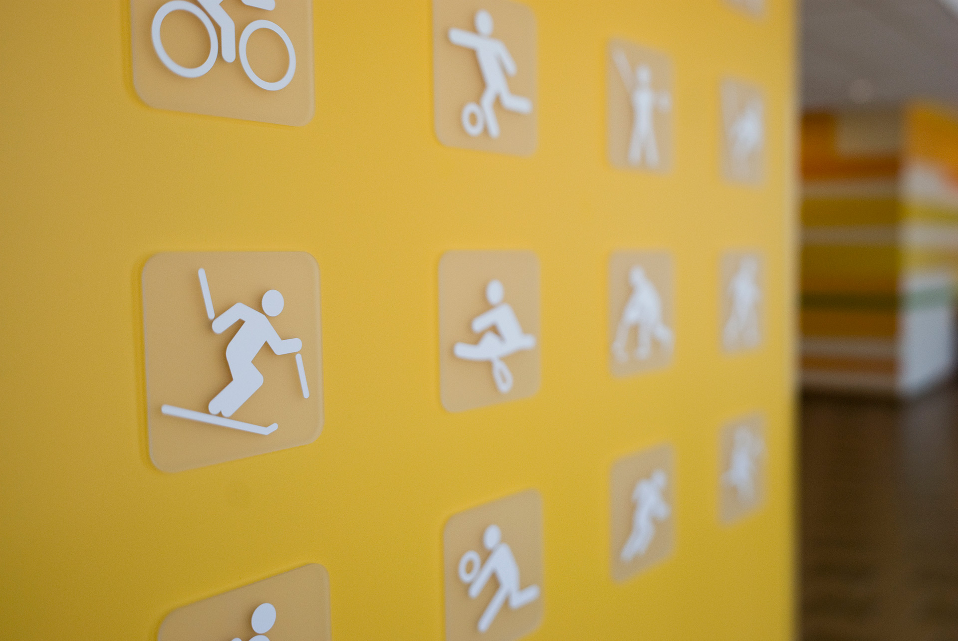 Acrylic panel branding display mounted with standoffs over wall graphics