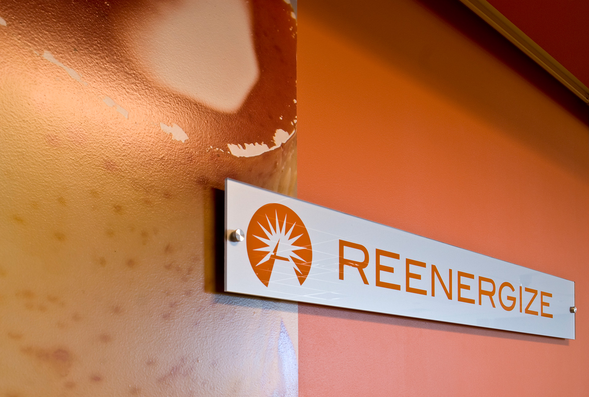 Acrylic panel displays layered over environmental wall graphics