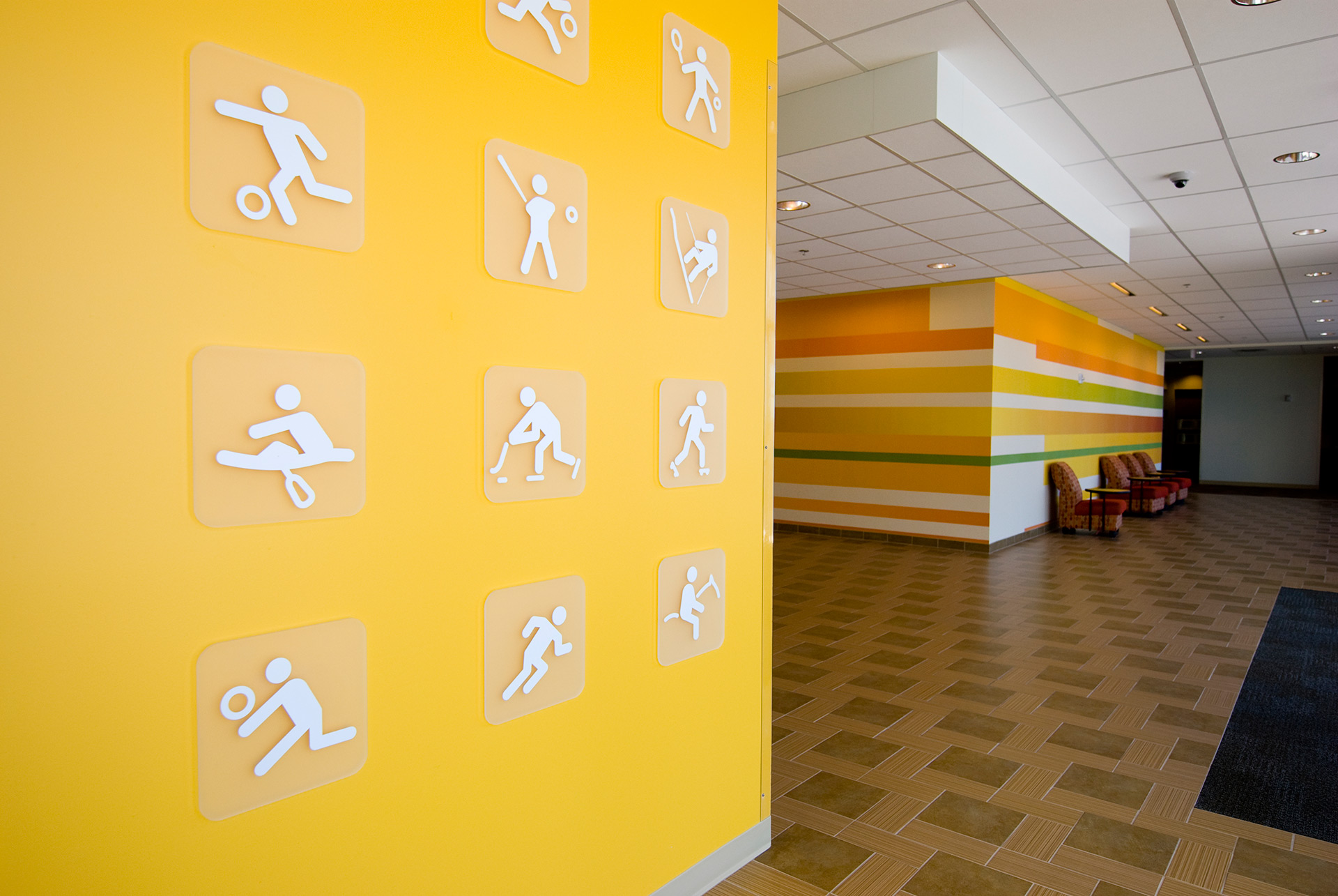 Acrylic mounted branding graphics display integrated with environmental graphics